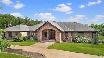 Incredible custom stone ranch situated on 32 breathtaking acres. Tucked away on your own private estate as you enter the home you will find soaring vaulted ceiling and an open stairway to the lower level. Off the foyer you will find a private study with built ins and a large dining room perfect for family gatherings. The vaulted great room with custom ceiling has a charming stone see thru fireplace to hearth room. Gourmet kitchen has custom cabinets, huge island/breakfast bar, granite and sub zero refrigerator and opens to breakfast room and hearth room. Main floor master suite with luxury bath and huge walk in closet. Additional main floor bedroom and full bath. Finished walk out lower level with 2nd kitchen, game room, rec room, bedroom and bath. Screened porch, 3 car garage & more. Your very own private retreat awaits you!