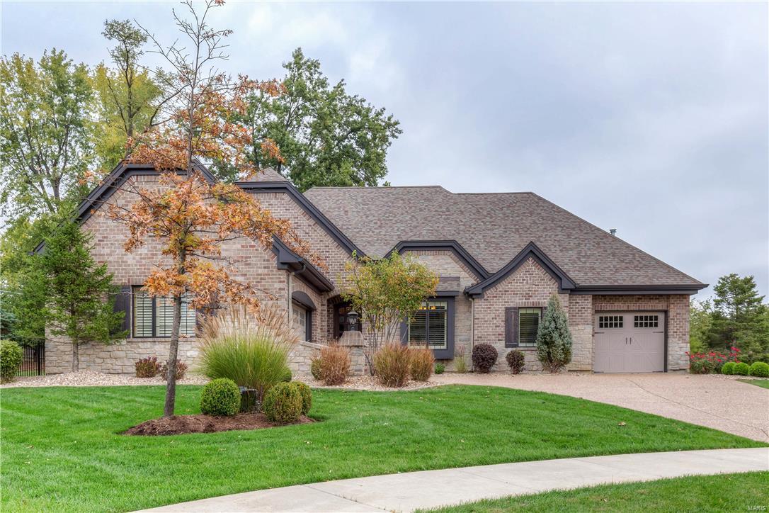 Offering serenity and sophistication with richly layered interiors, this 4 bedroom and 3.5 bath custom full brick and stone home is the perfect retreat. With over 5,000 square feet of beautiful spaces and incredible levels of finishes, the floor plan is adaptable to any lifestyle. Stunning open kitchen features an island that flows into the sunny great room with stone fireplace and vaulted ceiling. Main floor master demands a bay window, coffered ceiling, 3 custom walk in closets and luxury bath with large walk in shower and soaking tub. Upstairs are two nice bedrooms and full bath. The full walk out lower level is an entertaining "tour de force" with kitchen/wine room with limestone floor, media room, family room with stone fireplace, full bath, bedroom and great storage. Outside is a charming gazebo with WB fireplace, lower level patio with fire pit and beautifully landscaped private fenced yard.  3 car garage, sprinkler system and  main floor laundry room with utility sink
