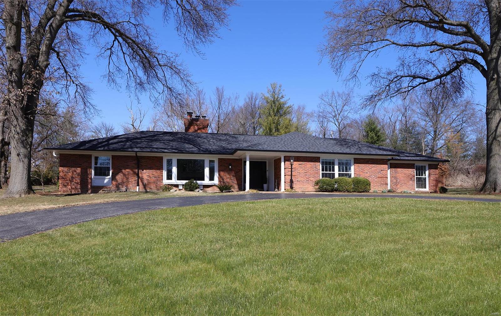 I am pleased to present for your consideration this beautifully maintained & newly updated all brick ranch in a prime Ladue location!  Step into the formal living and dining spaces that overlook the expansive front lawn and circle drive featuring newly refinished hardwood floors & a wood burning masonry fireplace.  Entertain your guests in the spacious kitchen featuring vaulted ceilings, a wall of windows that overlook the back private patio and landscape, center island, breakfast bar, planning desk & tons of custom cabinetry for storage.  Adjacent to the kitchen is a lovely family room with fireplace ( gas log insert), built in bookshelves, vaulted beamed ceiling and beautiful lighting.  The primary ensuite includes a beautiful sitting/sun room that also overlooks and walks out to a private back yard space for morning coffee or an evening nightcap. Includes his and her walk in closets and a well appointed primary bath with marble flooring. Included are 3 add'l. bdrms. & LL rec room. Additional Rooms: Sun Room
