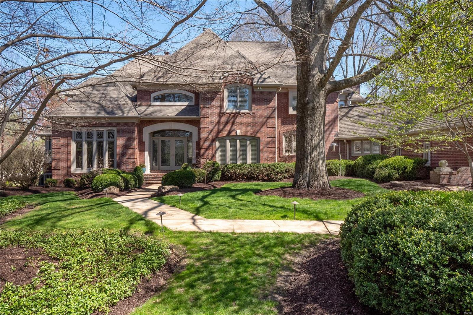 A rewarding escape combines casual luxury and sophisticated St. Louis living. This magnificent home offers high-end finishes and thoughtful design throughout. Over 7,000ft of richly-appointed spaces include a welcoming entry with grand, curved staircase, expansive two-story great room with fireplace and wet bar, professional-grade kitchen equipped with oversized island and high-end appliances, open breakfast/hearth room, office, and an elegant dining room. Primary bedroom suite with opulent bath is on the main, while the upper level features three more bedroom suites. Significant lower level with rec/bar area, pass-through fireplace, game room, and a large office that could be a 5th bedroom. The large back patio, overlooking the sparkling pool and lush surroundings is the perfect spot for throwing summer parties. Prime location; minutes to major highways, schools, hospitals, country clubs, and more. Additional Rooms: Mud Room
