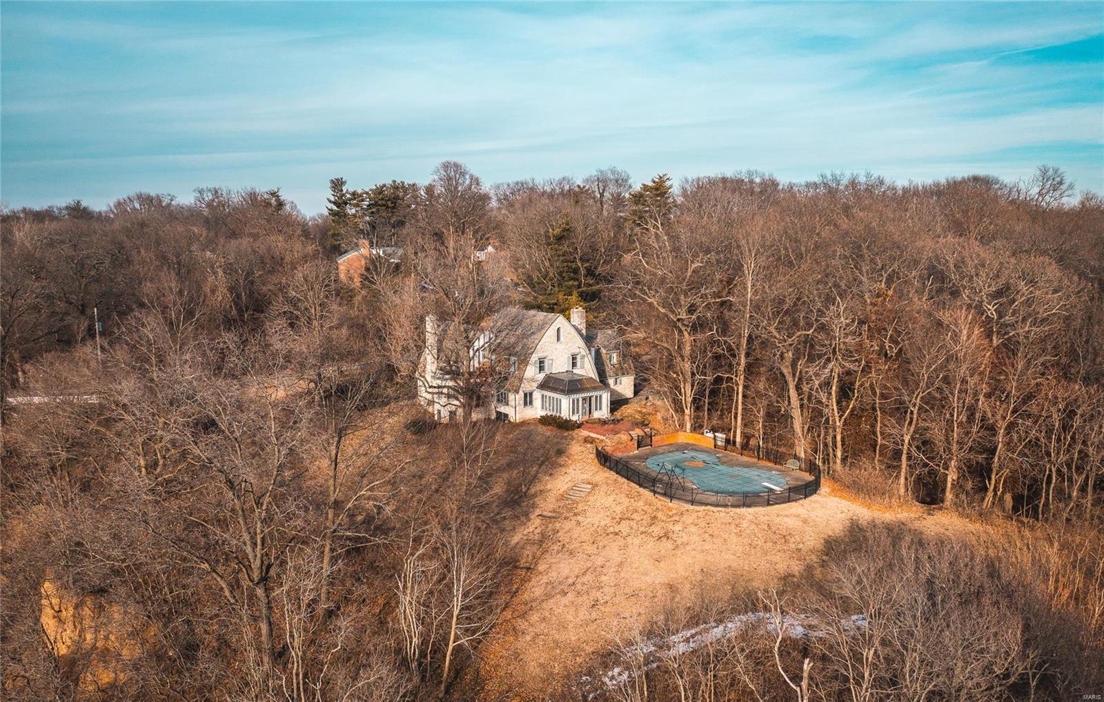 Rare and unique opportunity to purchase a beautiful stone home situated atop the Mississippi River bluffs. Located in one of Alton's highly sought after subdivisions, this carefully crafted build captures the perfect views down the river and can even offer a glimpse of the St. Louis Arch. The interior offers plenty of old world charm as well. Enjoy entertaining your guests around the in-ground pool or watching a sunset from the all seasons room. This is your chance to enhance a truly one of a kind home. Additional Rooms: Sun Room