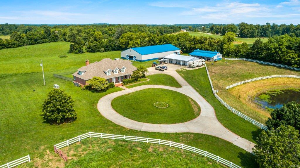 This beauty could be your personal "Southfork" home! Situated on 25.640 unrestricted acres, this equestrian delight features everything you need including a commercial 72x144 indoor riding arena, custom stables with wash bay, stalls, tack room and more. Need a place to store all of your toys?  You'll love having the 4 bar shop with full length covered porch and 24x30 lean too already waiting on you.  The two story, custom brick home features a chef's delight kitchen, 5 larger than life bedrooms, main level master suite, formal dining room, and a full unfinished basement offering lots of room to grow.  The home is situated beyond a driveway lined with mature trees that offer great privacy, and white vinyl fencing.  This home is truly one of a kind, so put this estate on the top of your list to see!  Just 1/2 mile from Jackson city limits. Internet options include At and T as well as satellite.