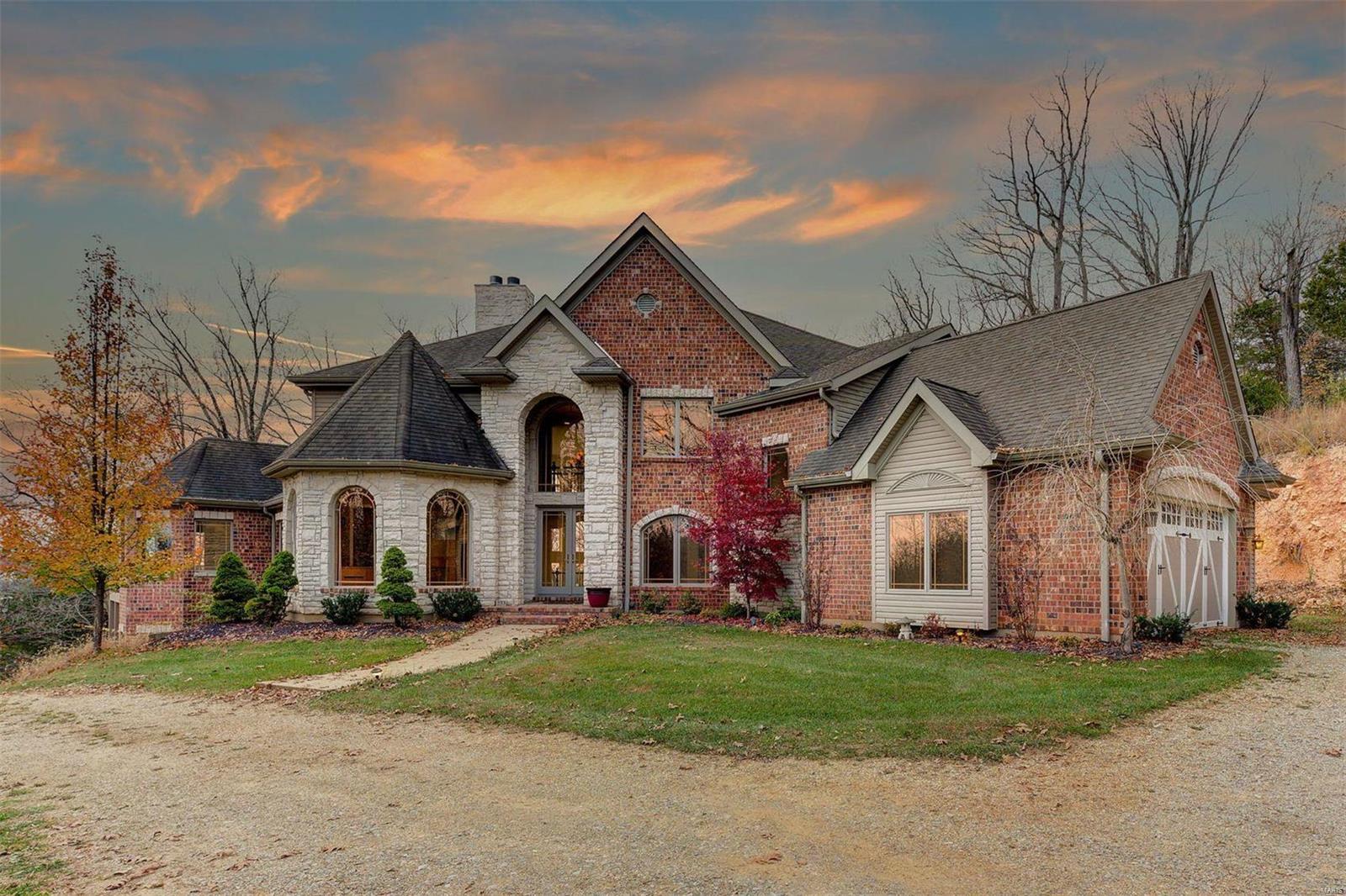 Your own private getaway awaits!  This gorgeous 4,900+sqft 1.5 story home sits on over 11 acres with beautiful bluff views & river frontage.  AAA-Rated Rockwood School District. This 5 bedroom & 6 bathroom home boosts close to 8,000sqft of total living space.  Luxurious custom home awaits as you drive past the fully stocked fishing pond with dock, additional carriage house foundation (waiting your finishing touches) & pull up to the grand brick & stone exterior of this beautiful home with 3-car attached garage.  Walking in the 2-story entryway with curved staircase, motorized chandelier, & marble flooring, you are met by the executive office & separate dining room. The large primary bedroom suite, located on the main level, offers a sitting area, deck, double closets & bathroom setup for a 2 person jetted tub, 2 vanities, & walk-in steam shower. Much more features remain such as the movie room. Price reflects the work needed to complete. Appraised in 2018 for 1.775M with completions.