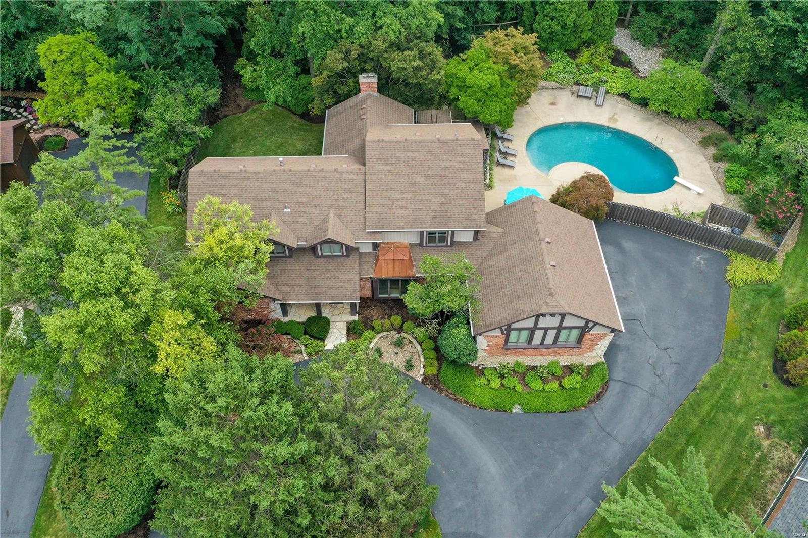Beautifully appointed 1.5 story, 6 bedroom, 4 full & 2-half bath home on a tree-lined cul de sac in the award-winning Ladue School district. Over 5500 sq ft of living space, w/2-story vaulted great room w/wood floors, lots of natural light & gas fireplace. DR w/wood floors. Gourmet kitchen w/Viking gas cooktop, Subzero refrigerator/freezer, granite, open to sun/breakfast room w/vaulted ceiling, large windows overlooking private landscaped backyard w/in-ground pool. The first-floor primary bedroom has a walk-in closet & built-in desk. The redesigned ensuite bathroom has dual sinks, a spacious spa-like shower, & soaking tub. 4 bedrooms w/2 full jack & jill baths on the 2nd floor. The finished lower level has a living area, wet bar, cabinets, custom wine cellar that holds 1000 bottles, fitness room, bedroom w/egress window & full bath w/sauna. Zoned HVAC, oversized 2 car garage, 1st floor laundry/mud room w/1/2 bath. Prime location near major HWY, hospitals, shopping and restaurants. Additional Rooms: Mud Room, Sun Room
