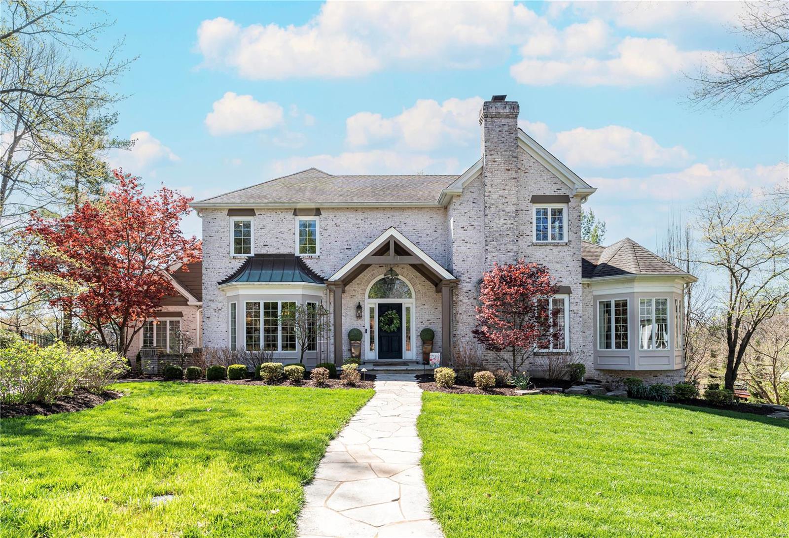 Situated on a charming Ladue lane adjacent to Tilles park, 12 Deer Creek Woods offers comfortable living with custom finishes. Off the front hall a formal dining room & cozy study lead to a beautiful kitchen which opens into the large den/hearth room with vaulted ceiling. A large primary suite with a recently updated bath, walk in closet and privacy deck completes the main level. Upstairs are 3 additional bedrooms, one en suite and the other a jack and jill.  The walk-out, finished basement has been fully updated with no detail forgotten. Use the remote black out curtains to transform the space into a media room, work out in the dedicated exercise room (which could be transformed into a sleeping area), or serve guests from the wet bar. Functional amenities include remote blinds in all the bedrooms, two generators, hot water circulator, and newer HVAC components. Outdoors enjoy the large patio with a louvered canopy and outdoor fireplace surrounded by the professionally landscaped yard. Additional Rooms: Mud Room
