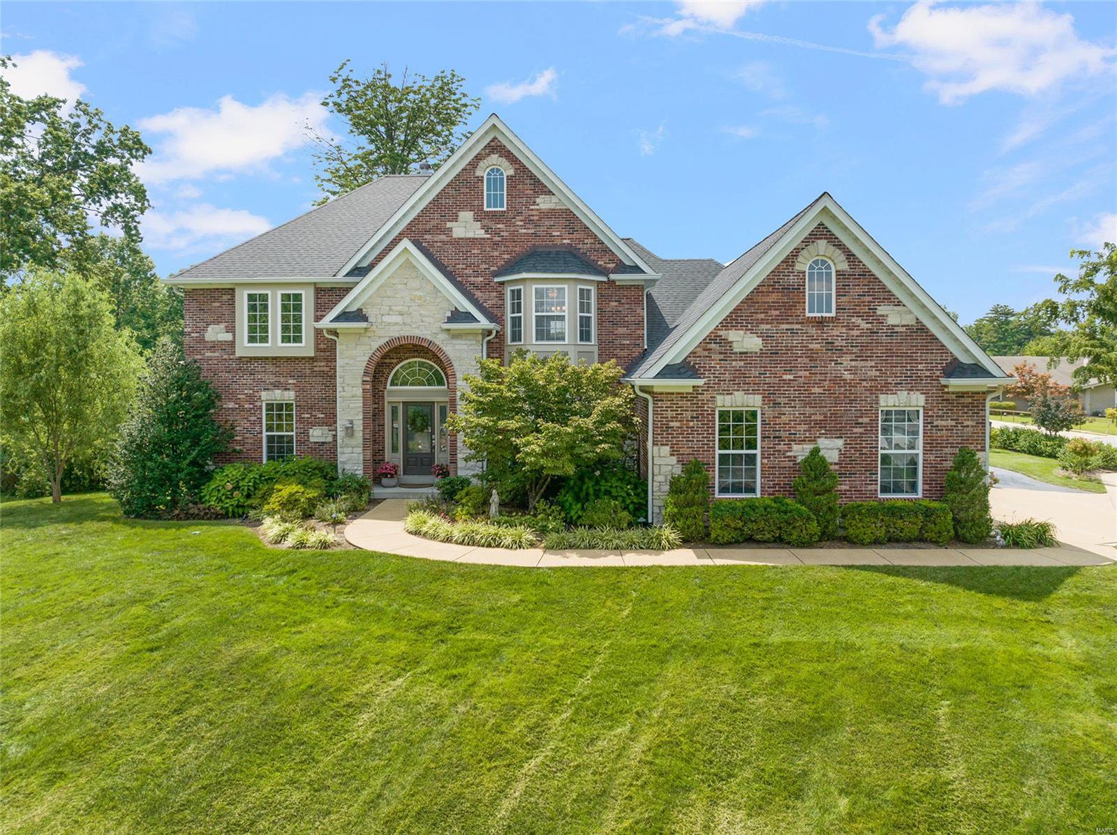Welcome to this impeccably cared for home, inside & out! The appealing light & youthful décor invite you into the open floor plan. Features incl a grand staircase overlooking the 2 story great room w/floor to ceiling windows, hickory floors, living room, dining room w/coffered ceiling & bay window, upgraded millwork & pleasing archways. The kitchen has granite counters, ss appliances & opens to the breakfast room & hearth room w/vaulted ceiling & stone fireplace. The main floor primary suite has a walk-in closet & bath w/double sinks, tile surround shower, separate tub & private WC. Upstairs there are 3+ bedrooms & 2 baths. The spectacular LL has a projector screen/viewing area, wet bar, rec room, Murphy bed, full bath. Outside you'll find a lovely gazebo, stamped concrete patio, attractive landscaping & water feature. Don't miss the main floor laundry, 3 car garage, irrigation system, newer roof, HVAC & water heater. Enjoy the friendly cul-de-sac & popular Harwood Hills neighborhood!