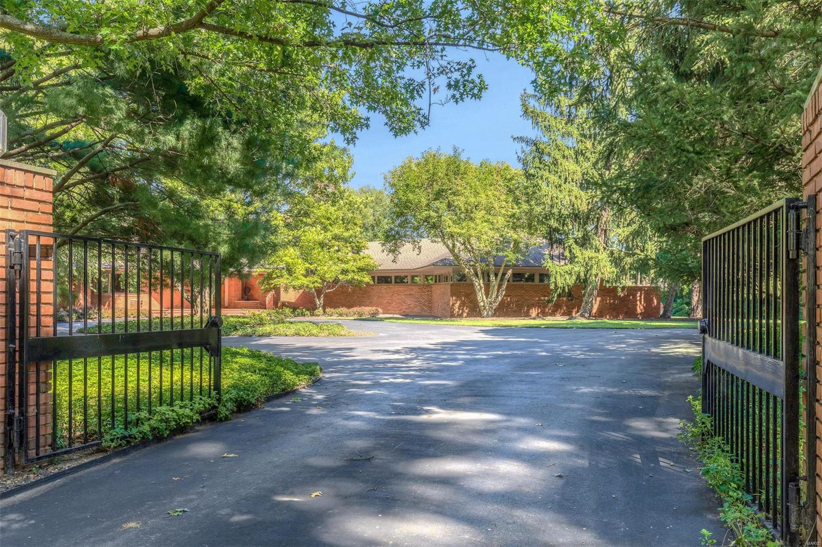 Imagine living in an architecturally significant home, tucked away on a private wooded lot, that overwhelms from the moment you enter with angled walls, tall ceilings, lighting that complements each room and of course, walls and niches designed for fabulous artwork. An abundance of windows allows incredible views of the pool and mature grounds.  This is main floor living at its best! 11 Terry Hill Lane is contemporary in style and thoughtfully designed by the renowned architect, Ted Christner.  It is built to commercial standards and maintained in the finest fashion. Entertaining is seamless with a dramatic great room, a classy bar, opening to an oversized dining room which flows into the kitchen. Highlights include a Master Suite with his/her baths & dressing areas, second bedroom suite, office/guest room, intimate family room, finished playful lower level, 3 car garage, generator, pool house and more.  There is nothing ordinary about this home--It is exceptional.