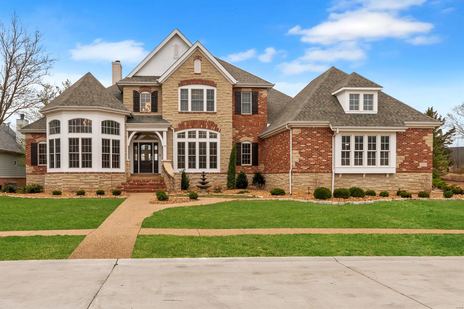 Stunning Custom 4bd 4.5ba 1.5 story atrium home w/ finished walkout LL located in the prestegious Estates at Hawks Ridge. Custom built upgrade features list is immense: lighting, 8' doors, soaring ceilings, media & speakers, trim & millwork, & the list continues. Professional designers & trades exquisitely updated & upgraded home in 2025. Strong exterior appeal & street presence on phenom lot: Layout, finishes, features all impress: Opulent Entry Foyer, vaulted study, wet bar, formal dining, updated custom kitchen/hearth area: stone tops, pro series appliances, Gas cooktop, wine + bev + built-in fridges, large island w/prep sink, W/I pantry; Open to living & huge deck. Main floor primary suite: coffered ceiling, dual closets, jetted tub, sep shower, designer light & plumbing fixture. 2nd FL offers Juliet style landing, 3 beds, 2 baths. Walk out LL w/ theater room, rec room,& full bathroom. Exterior: Professional landscape, large maintence free deck, level yard, and patio.