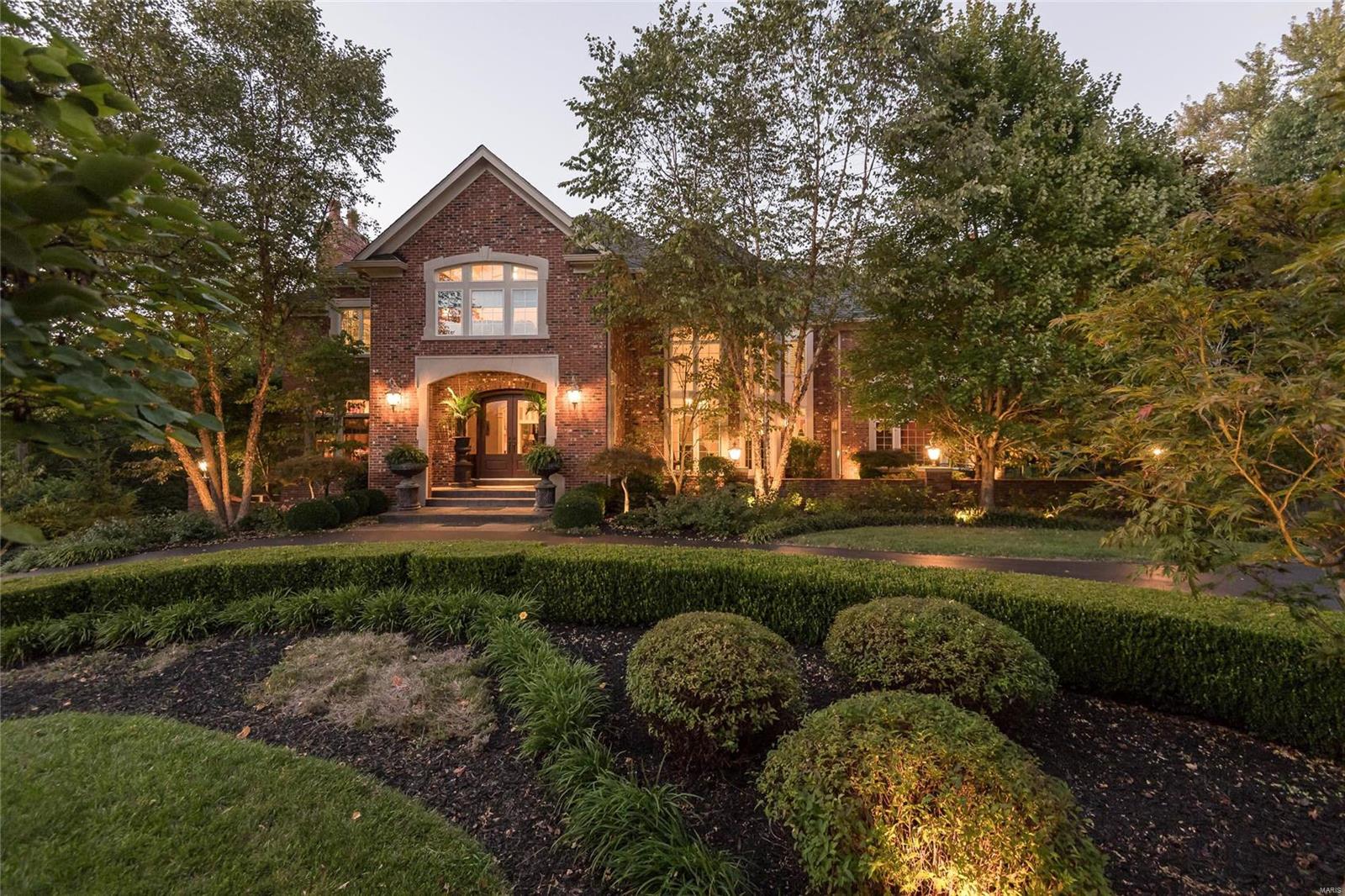 You will love the recent renovations to this stunning brick home in the heart of Ladue. Dark-stained Brazilian cherry floors  flow through most of the 1st level including the master MBRM suite and great room with its bold fireplace and plentiful windows--a perfect contrast to white marble in the foyer, dining room and guest bath.  The soft white custom cabinets and the light fixture above the island complement everything nearby. You'll discover a real cook's kitchen when you see the 6 burner Wolf range and ovens, Sub Zero refrigerator, wine cooler, Miele dishwasher and built-in coffeemaker. The master bath highlights use of glass and marble and  now has a much-in-demand soaking tub. All three 2nd level baths were brought current, as well. On the LL check out the fitness room, sleeping/office space, full-size bar, wine cellar, and seating area, just steps from doors opening to a covered veranda. A magnificent pool and waterfall feature, nestled in lush landscaping are picture perfect!
