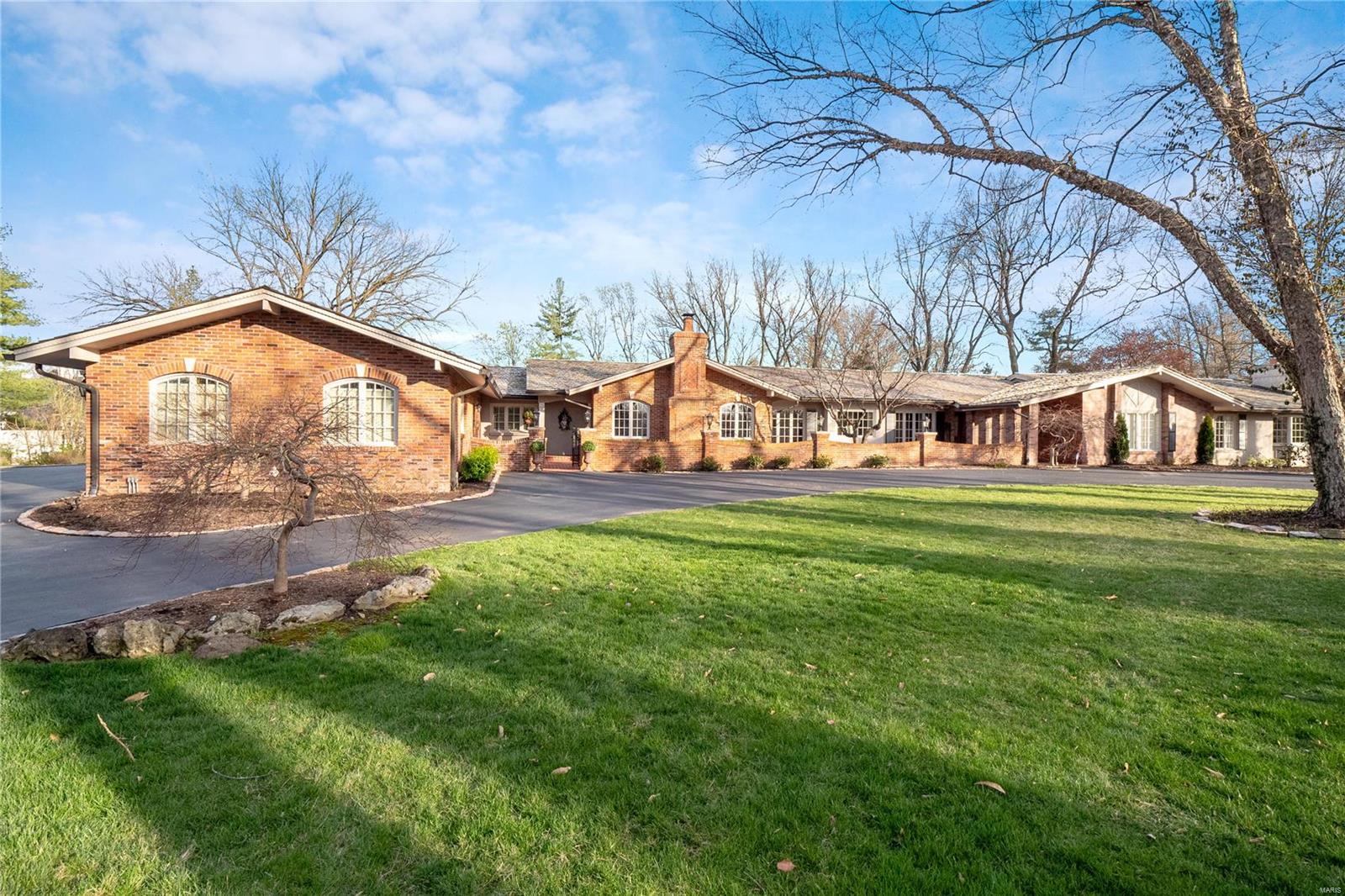 This home is enchanting! A magnificent ranch with a glamorous yet comfortable feel and a distinctive and unique flair! Such spaces and details are uncommon in this area. Richly updated and expanded, all rooms have been touched with an eye for design and an appreciation for the welcoming and lavishly landscaped outdoors. Kitchen wing is well equipped and appointed and opens to hearth area and dining room, large laundry/office and adjoining guest suite addition. Two living/family rooms in the center of the floor-plan join to one another plus adjacent greenhouse room and year around separate sunroom/family room. Luxury master suite with exterior access plus two additional ensuite bedrooms. Gala sized terraces and brick patios, seamlessly lead to private pool and overlook the 1.8 acre surrounds that includes a fire pit. 3 car garage, immaculate maintenance plus a finished lower level entertainment room with bedroom and bath. A distinctive Ladue estate not to be missed. Additional Rooms: Sun Room