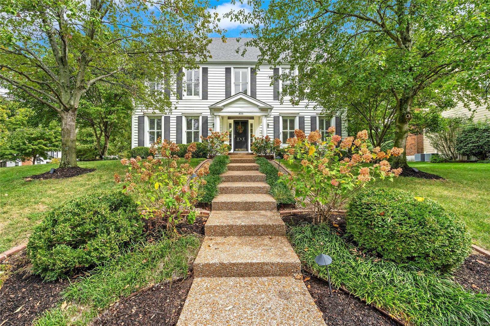 Located in the highly desirable Waterford Place neighborhood of Kirkwood, this stately 5-bedroom, 4-bath home sits on a beautiful corner lot with mature trees & lush landscaping. The bright, two-story foyer opens to formal living & dining rooms featuring 9 ft. ceilings, exquisite wood detailing & plantation shutters. The spacious eat-in kitchen includes handcrafted Amish-made cherry cabinets, new quartz countertops, a 10 ft. island & stainless steel appliances. The  cozy family room boasts custom cabinetry surrounding a brick fireplace. Convenient main floor laundry room with built-in lockers. Upstairs, the vaulted primary suite features new carpet, an updated bathroom, walk-in closets, separate shower & Jacuzzi tub & 3 add'l bedrooms! The expansive lower level offers a second living area, a craft room, 5th bedroom w/ egress window & full bath. Great for guests! Side-entry 2-car garage, brick patio and lovely gardens complete this home. Close to hwy.'s shopping & top rated schools!