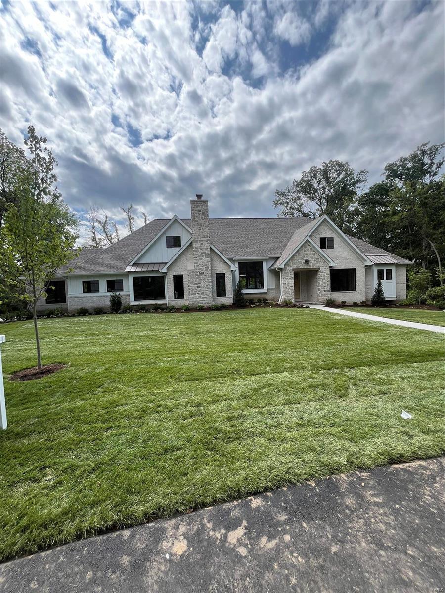 New custom home by Flower Homes. Nestled in the award winning Ladue school district with quick and easy highway access. This stunning ranch home offers countless features. To name a few: Foyer custom wood paneling, vaulted & beamed gathering room displaying premium horizontal gas fireplace. The spectacular kitchen custom cabinets, thermador appliances, double refrigerator/freezer, and granite countertops. Cozy hearth room with full masonry fireplace and wine bar. Vaulted sunroom with custom beams, floor to ceiling windows, and gas fireplace allow private wooded view. Primary bedroom with coffer ceiling opens to duet Primary Bath w/ private his and her spas. Endless fun to be had in walk out Lower Level w/ large rec room, 2nd kitchen, 2 bedrooms, and 2 full baths. In ground, zoned irrigation system and custom design landscaping. Additional Rooms: Sun Room