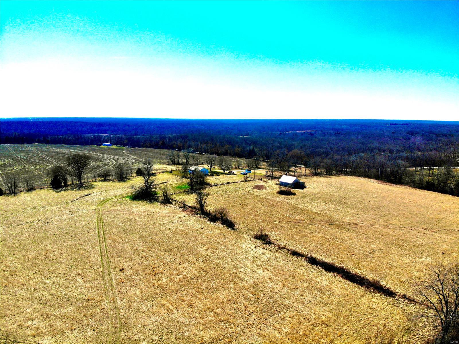 Welcome to a sprawling 185.94 acre farm offering an unparalleled blend of rural charm and multifunctional potential! Nestled in the heart of serene countryside, this expansive property is a haven for those seeking the perfect balance of agriculture, recreation, and income generation. The centerpiece of the estate is a farmhouse that boasts three bedrooms, and one bathroom, modern kitchen on a full basement. Whether used as a primary residence, or a weekend getaway, this country home offers versatility and charm. 

This property features row crop land, offering opportunity for agricultural investment. For outdoor enthusiasts, the vast expanse of pastureland provides ample space for grazing livestock, equestrian pursuits, or recreational activities such as hiking, horseback riding, or ATV adventures. Beyond its agricultural offerings, this farm is a haven for hunters, with abundant wildlife and prime hunting grounds for deer, turkey, etc., making it a paradise for outdoor sportsmen.