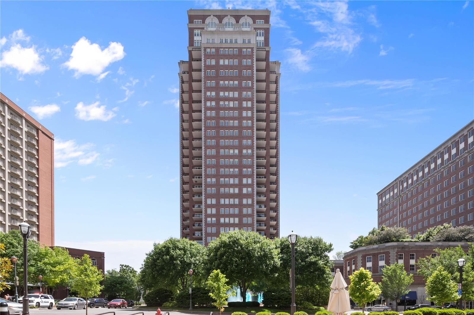 Luxury living at the Plaza in Clayton. Custom designed, 2 bedroom, 2.5 ba residence on the 10th floor.  2 balconies overlook park like pool area/dog park. A 10'x10' foyer w/custom cabinets lead to open, sophisticated spaces of living room, dining room & kitchen. An impressive kitchen w/custom European cabinets, a large island w/gas cooktop, Sub Zero & Miele appliances will delight any cook. Granite counter tops, a breakfast bar & eating area complete the kitchen. A large master suite w/custom walk-in closet, luxurious master bath, separate tub and shower. A den/library off the master bedroom offers built-in bookcases & cabinetry. The 2nd bedroom offers the opportunity for family or guests. A large utility/laundry rm provides excellent storage. Enjoy the exceptional services the Plaza offers: 24-hour concierge service, valet parking, on-site management, state-of-the-art fitness center, an elegant club room, park like pool setting, dog walk, plus all the delights Clayton offers. Location: City, End Unit