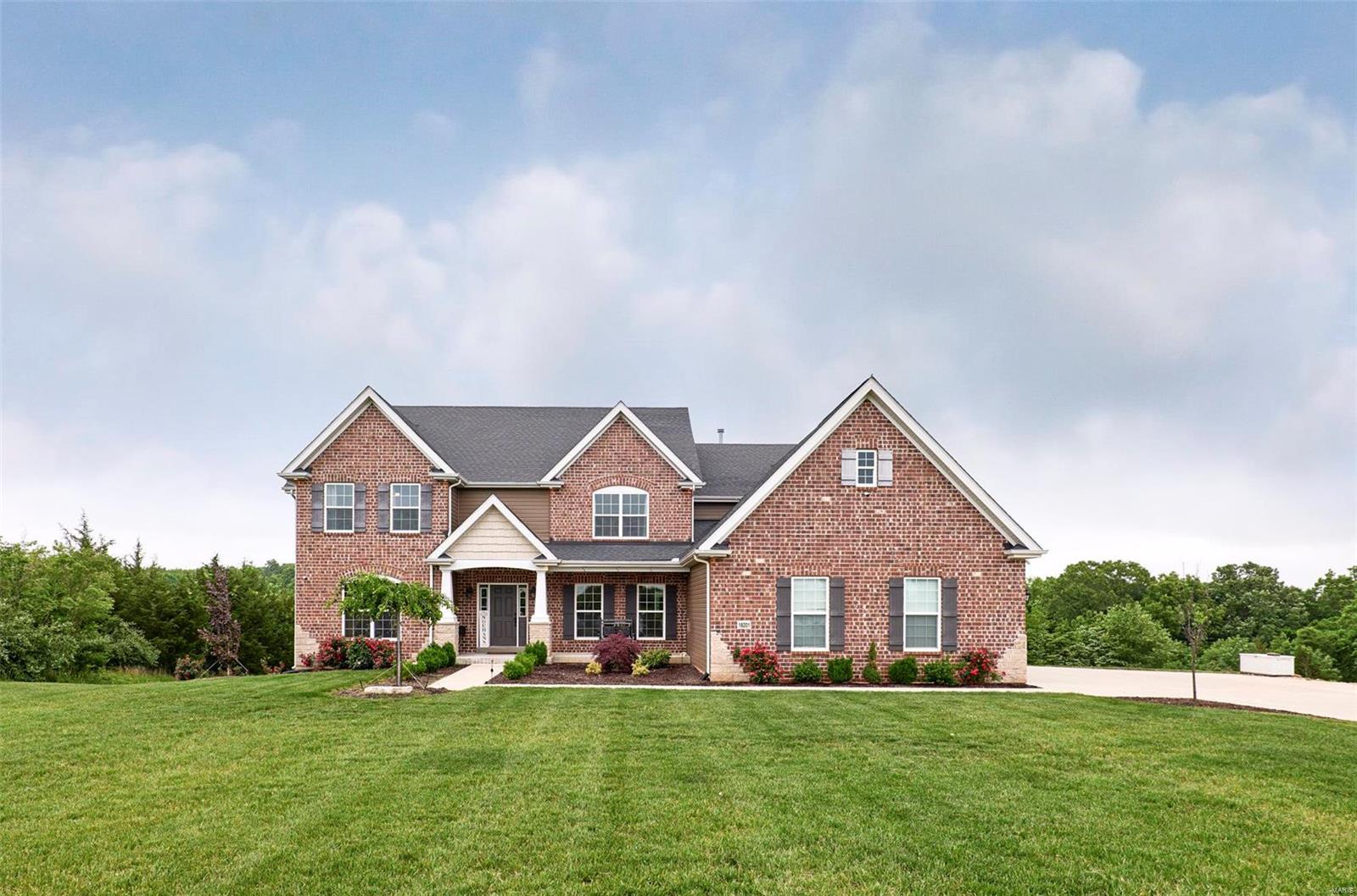 GET READY TO FALL IN LOVE! 4,928 SQFT 3.5 YEAR OLD 1.5 STY ON A GORGEOUS 5-ACRE VERY USABLE WALK-OUT LOT, YOU CAN HUNT ON YOUR PROPERTY. This home was designed to sit back from the street and features a double-wide driveway with an additional rock pad for multi-use. Custom built Ellington with attention to detail by the seller. The wall of windows creates a very open floorplan where each room flows nicely. The beautiful white kitchen was upgraded with Cambria quartz countertops, double stacked cabinetry with lit and glass uppers, GE “Café” appliances,5 burner gas range, double ovens. Large master suite with spacious master bath, oval freestanding tub, oversized shower with seat and granite tops. Large upper bedrooms with great closet space. Game/Theater room has builtin speakers for and insulated and designed for family entertainment. Deep side-entry 3 car garage, Sprinkler Sys and Security system with cameras around the perimeter of the property. Great Location and Quaint Development!