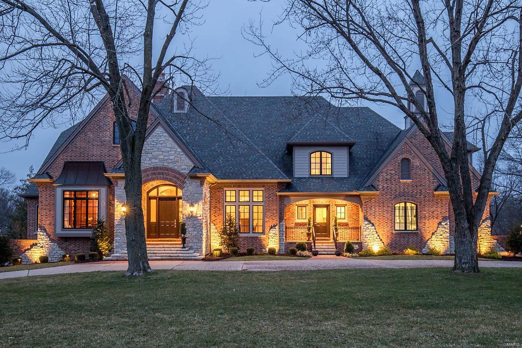 Beautifully designed French Country Estate home with over 8800 sf of living space enhanced by distinctive architectural elements & extensive updates throughout. Impressive octagonal foyer leads to paneled library with custom built-ins, formal dining room & stunning great room with wet bar, granite fireplace flanked by bookcases & French doors that open to veranda. Designer kitchen featuring glazed cabinetry, granite countertops, commercial grade appliances, planning center & butler’s pantry adjoins breakfast room with bay window & vaulted hearth room highlighted by floor-to-ceiling stone fireplace. Coffered master bedroom suite with marble bath with shower spa offers a relaxing retreat. The 2nd floor extends the living quarters with 3 additional bedrooms, 2 full baths & bonus room. Lower Level includes its own “Irish Pub,” family room with fireplace, media room & game room plus workout room, 2nd kitchen, guest suite & pool bath. Situated on 1+-ac grounds with pool & patio with firepit.