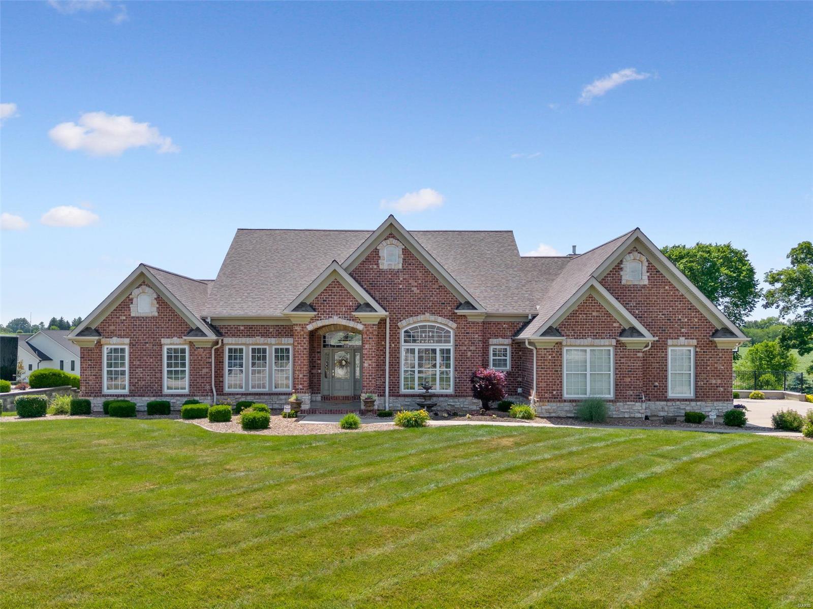 Stunning atrium ranch in the sought after Westborough Estates subdivision. This 5 bed/4 bath home is magnificent, boasting beautiful updates throughout 5,400 sqft of livable space. You'll love the curb appeal showcasing a classy brick and stone exterior, 3 car garage, large deck, security camera system, and lavish salt water pool complete with pool house, kitchen, half bath, stone fire pit, waterfall feature and brick fireplace - perfect for entertaining! Inside offers an impressive open concept layout, hardwood floors, high ceilings, elaborate crown molding, fireplace, updated baths, main floor laundry, sonos surround sound system, and grand windows. The kitchen is furnished with quartz countertops and SS appliances. The main level offers 4 bedrooms including a glamorous primary bedroom suite with a large walk-in closet, spa-like bathroom with a soaking tub, separate shower and dual vanity. The lower level sparkles with its large family room, game area, wet bar, and bonus bedroom.