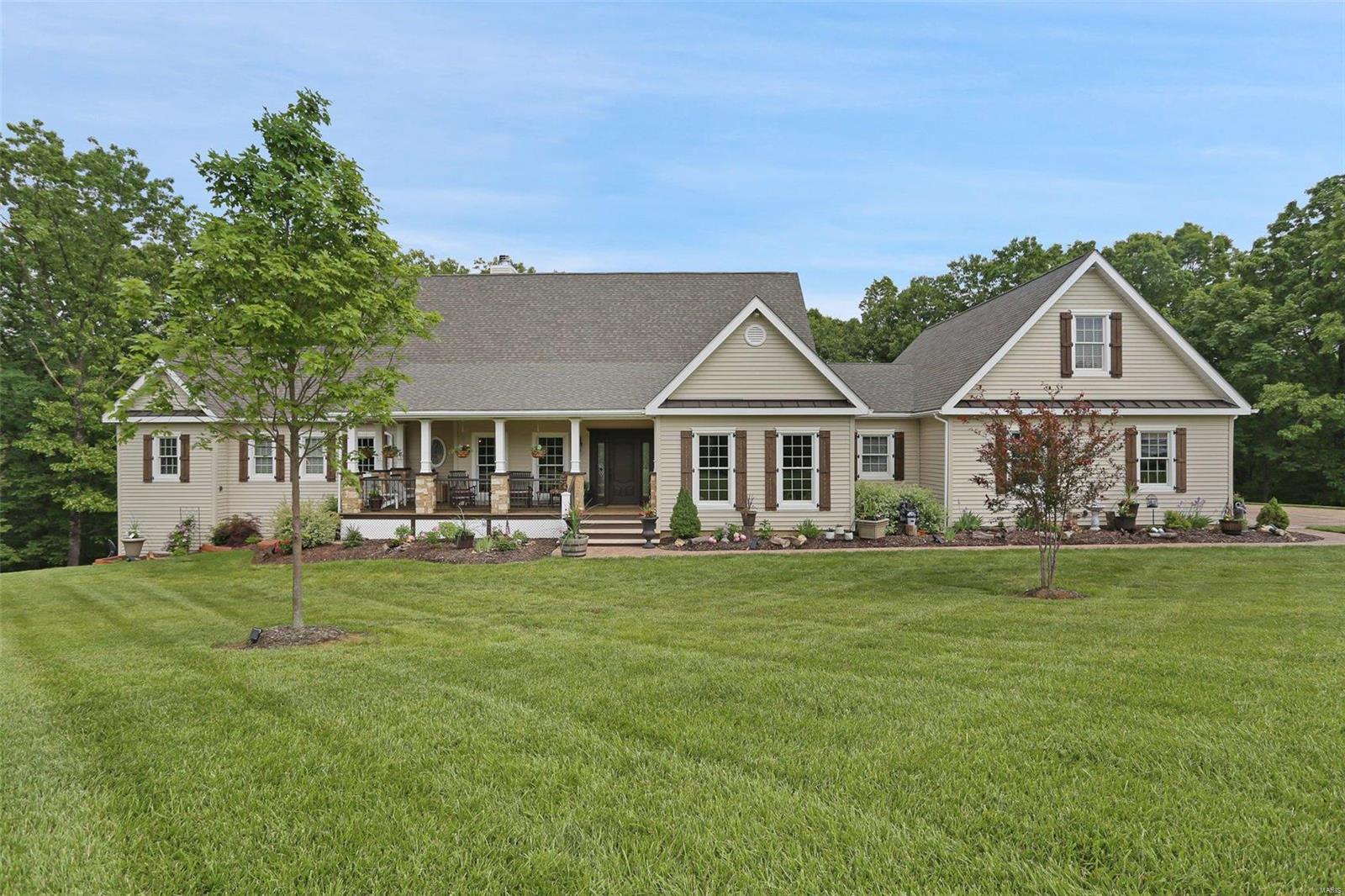 This 5400 sf French American Country Home designed by Dick Busch Architect is nestled on a 3.15 acre, wooded lot in Wildwood.  4 BR, 4 full BA including the main floor master suite featuring a fireplace, seating area and adjoins a verandah.  Luxury MB area with double shower, Jacuzzi hot tub, double vanity and separate walk-in closets.  The 600 sq. ft. loft offers privacy with a sitting area, full bath and beautiful BR.  Upper and lower level laundry areas.  The kitchen is fit for a Chef, gas range/professional hood, custom cabinets, breakfast bar and large walk-in butler’s pantry.  Open hearth-room with fireplace.  The walk-out LL offers an entertaining area, fireplace, full bar area and game room.  Luxurious dining room with custom wall treatments from France and fine fixtures.  Formal paneled study room.  Outside enjoy a large covered, wood burning fireplace and outdoor kitchen.  3 car garage, covered front porch, stamped concrete drivew Additional Rooms: Mud Room