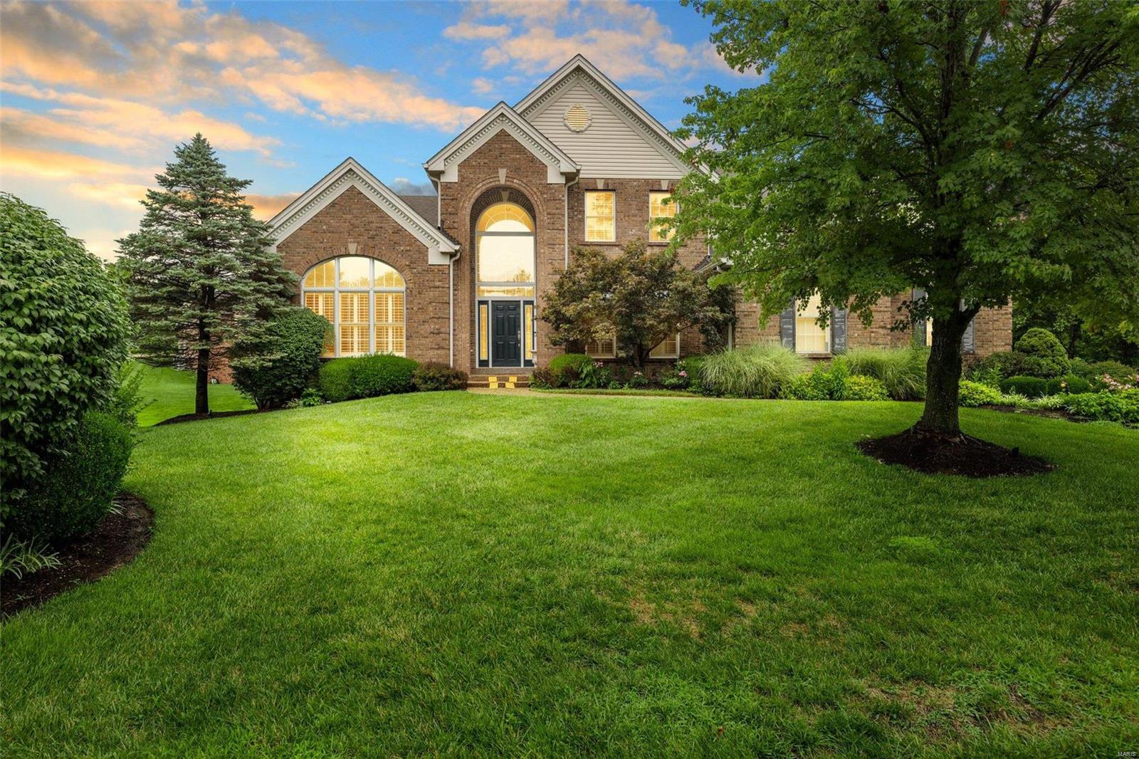 Stunning Town & Country estate home offers custom upgrades throughout.  Step into the grand entry foyer with marble & curved staircase flanked by box beamed office and a large dining room complete with butler's pantry and extensive custom millwork that welcomes you to the luxury that awaits.  The kitchen has 42" custom cherry cabinetry, granite countertops, center island, and breakfast bar.  The breakfast room invites you to walk out on to the composite deck and take in the beauty of the premium cul de sac lot, or you can settle into the warmth of your hearth room complete with stone fireplace and vaulted ceiling.  The main floor master suite has his and her walk in closets, and a large bathroom complete with whirlpool tub, two vanities, and separate shower.  Upstairs are three MASSIVE bedrooms, one with private bath and two with a Jack & Jill bath.  Lower level has two full baths, bar, built in entertainment center, and much more. Many new upgrades! House appraised at $1.32 million!