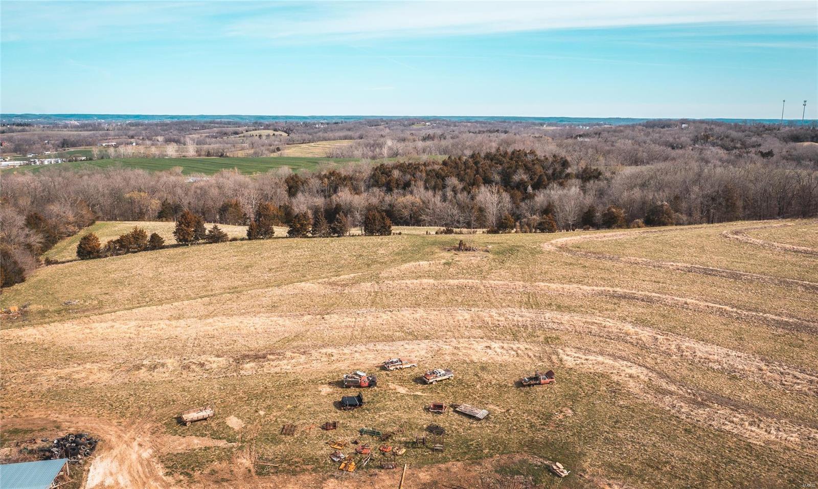 80 Acres M/L outside City Limits of Washington, and minutes to town. Multiple Tax ID's to this property. This property offers a great secluded entrance property that has some spectacular views. Multiple building spots for those that want to build that dream home and possibly renovate the 1800's built Farm Home. It has a 1900 built barn that was still in use for cattle up until the fall of 2021. Has a BIG shop that can accommodate the bigger equipment or vehicles to work on or store. Hay Barn Equipment Shed are very well built and store lots of things to keep from the weather. 40 acres M/L of Pasture for your grazing animals or hay to cut for the winter. This could be your hidden gem in Franklin County for the family farm retreat. Property is also already surveyed into 8-10 acre parcels with the county called Owls Nest Subdivision if someone wanted to develop the property into 8 large acreage properties.