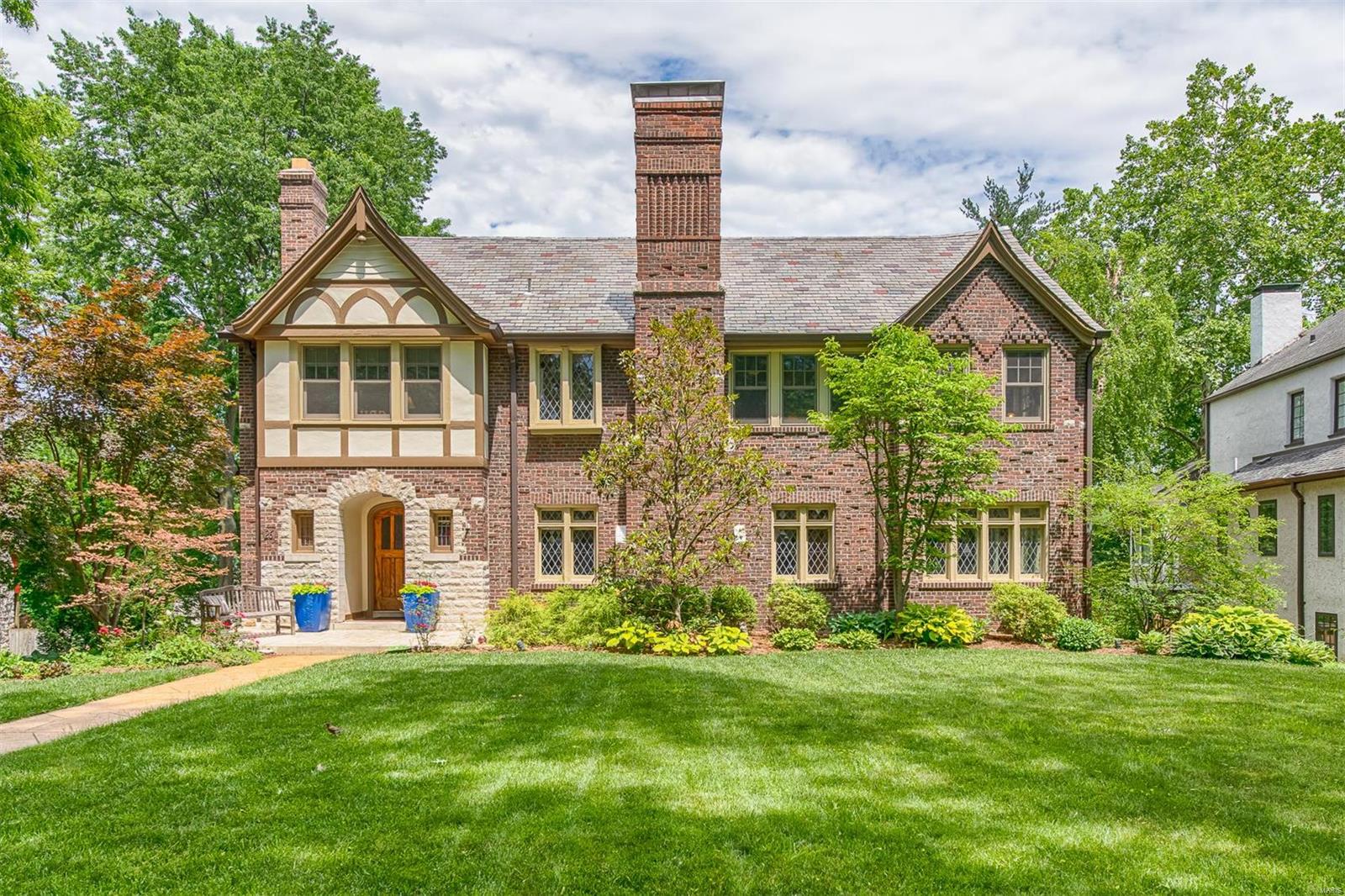 Gorgeous Tudor-style home sitting high in the heart of Claverach Park. With over 4,000 square feet of living space, this property is completely renovated w/ loads of original charm. Enter into a large entry foyer that leads to a spacious living room w/ a decorative limestone fireplace. The eat-in kitchen has been updated from top to bottom including stylish lighting, beautiful neutral cabinetry, granite counter-tops & stainless steel appliances. The main floor features a large family room & dining room w/ terrazzo floors & access to a charming, relaxing sunporch as well as a deck for grilling & entertaining. Upstairs, you will find a master suite w/ a spacious walk-in closet, custom master bathroom & second-story laundry. This floor also features two additional bedrooms, a fully updated bathroom & an office space w/ another private sunporch. The third floor serves as a second master suite, or the perfect space for a guest w/ a private bathroom & an impressive amount of closet space.
