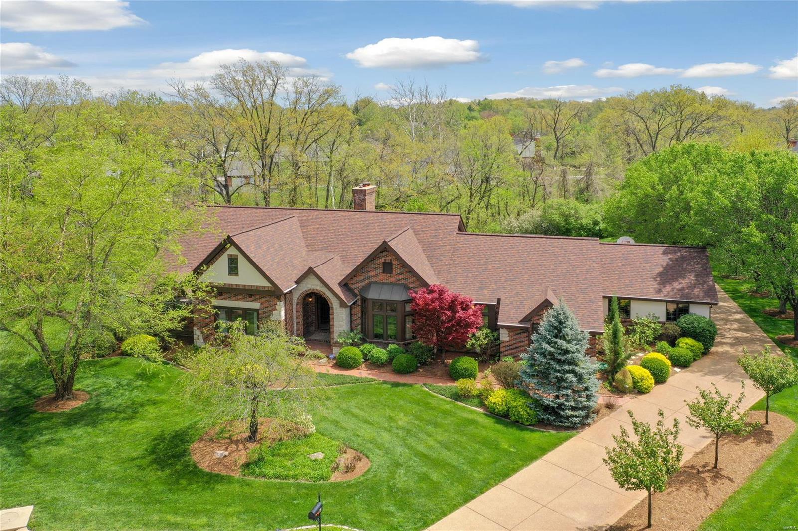 H2177 Brick & Stone Executive home in sought after Town & Country location. .78 acre level private lot on cul-de-sac. Adjoins common ground. Beautifully landscaped w/back yard fountain that cascades down to a pool & firepit. Three car garage. 3400+ SF ranch home w/4 bedrooms, 2 full, 2 half baths on ML. Lovely cherry cabinets with granite tops. Island eating bar. Dacor double ovens w/5 burner gas range. Sub-Zero refrig, Bosch dishw, Sub-Zero wine cooler & icemaker in the wet bar area of kitchen. Porcelain floor tiles. Cumaru Wood floors. 2-sided stone fireplace warms the living & library areas. Built-in book shelving. Cathedral ceiling w/beams in living room. Formal dining w/bay. Fabulously updated master suite offers 2 WI closets, 5' shower, soaking tub & 2 separate lg vanities. W/O LL has multiple entertaining areas w/wet bar & brick fireplace, bath, bedroom & several bonus rooms. Tiger Wood Deck w/pergola & built-in smoker, gas grill, eating bar & flat screen. See att detail sheet.