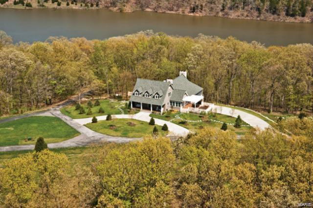 This extraordinary 4 BD, 6BA family retreat sits on 92+/- acres. Some of the many luxurious features in the home include, hand-honed timbers, distressed hardwood floors, stone floors and countertops, custom cabinets, stone fireplaces, high-tech sound and TV, and exquisite top of the line fixtures. Experience the amazing outdoors in the comfort of the screened porch, the cozy sunroom or thru the many beautiful large windows. This home is perfect for entertaining with two magnificent great rooms. Enjoy the grounds of this estate with park like amenities, a pavilion, softball/baseball/soccer fields, sand volleyball, basketball courts, fire pit, and paved walking trails. Plus access to Callaway Lake with private dock that is perfect for cruising on a pontoon, fishing or just taking a swim. This estate was built with excellence and is perfect for a weekend get a way or every day living. Every detail has been thought of including a 400 amp back up generator. Your buyers won't want to leave! Additional Rooms: Mud Room, Sun Room