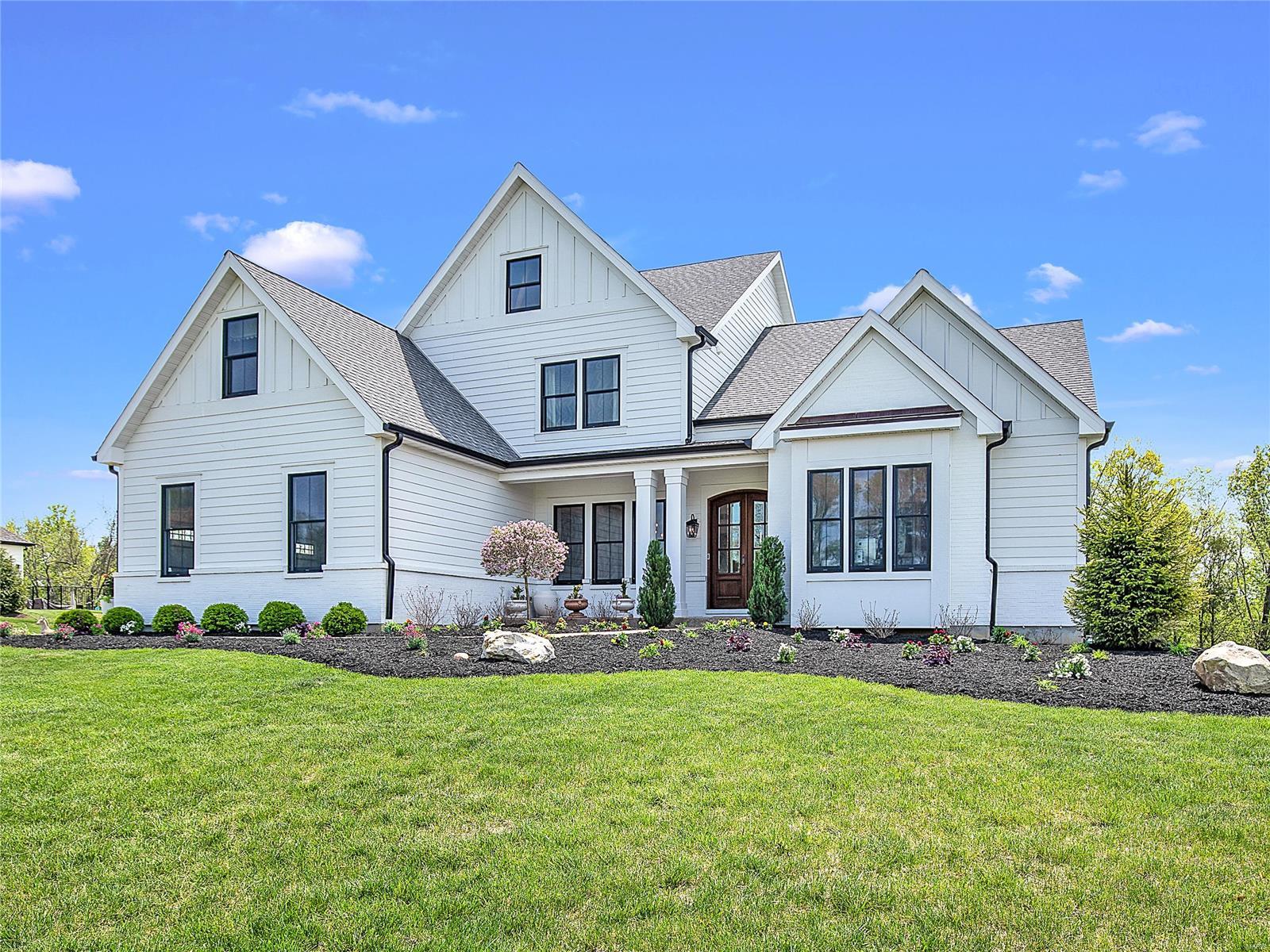 Beautiful newer custom Town & Country home built by Manlin & located on a private acre lot. The entry foyer opens to the spacious dining room & study w/vaulted beamed ceiling. The great room & hearth room offer gorgeous box beam ceilings, built-in bookcases & fireplaces. The designer kitchen has appealing quartz countertops w/ stunning subway tile, center island, Wolf appliances, Sub Zero refrigerator,& glass front cabinetry. The main floor master suite has a coffered ceiling & box bay window. The master bath has "his" & "her" vanities, a walk-in tile surround shower, soaking tub, & 2 walk-in closets. The main floor has breathtaking hardwood floors, 10' ceilings throughout & main floor laundry. Upstairs there are 4 additional bedrooms, 2 full baths & 2nd floor laundry. The LL has a nice rec space, wet bar, bedroom, 4th full bath & ample storage for future expansion. The gorgeous double doors & nicely landscaped yard invite you into this wonderful opportunity! Additional Rooms: Mud Room