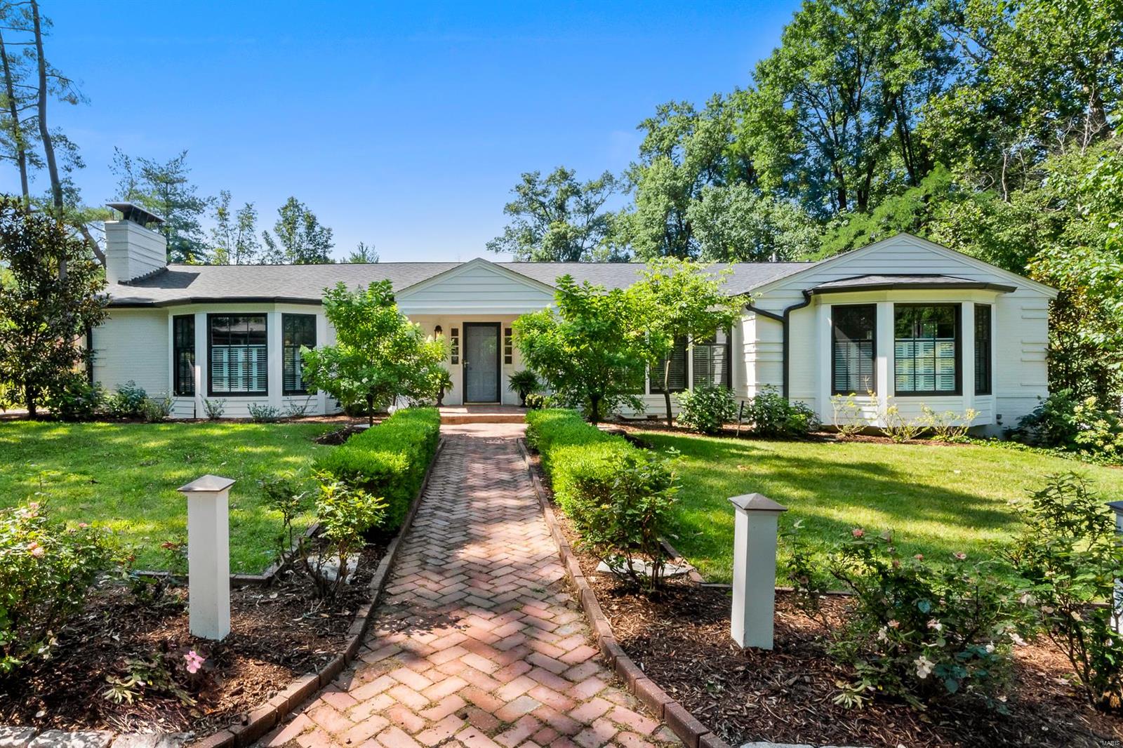 Here is your private oasis in a pristine Ladue location! This classic & elegant one story Ralph Lauren style home is a knock out. A convenient front parking area leads you to the entry to be greeted by an attractive great room with rustic beamed ceiling & brick hearth. Both the great room & dining rooms are enhanced by bay windows, plantation shutters, & wide plank pine floors. The entry has a lovely half bath. The sunny kitchen, with center island & top of the line appliances (2021, never used) overlooks the lovely 14x28 pool. Enjoy the cozy den next to the kitchen with walk out to the deck. At the west end are 2 bedrooms with Jack & Jill bath, & stacked washer/dryer. The primary bedroom suite (east end of home) has an adjoining office, access to the back patio and pool, & newer primary bath with large shower. The home & pool area are enhanced by beautiful landscaping. Freshly painted in neutral tones, new HVAC (2022), electric box (2021), LL with full bath, 2 car garage. A Ladue gem!
