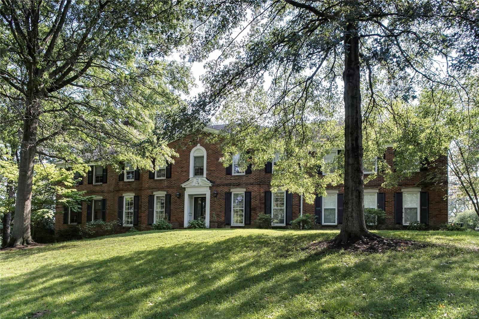 BACK ACTIVE. Striking estate being sold As-Is; located on a deep 1.8-acre lot in one of Ladue's most private neighborhoods. Lovely brick Colonial home has many updates, including kitchen, breakfast room, & a three-story addition. Property is ideal for a renovation, with 5,365 square feet of living space. Lovely foyer opens to living and dining rooms, a paneled family room and a gorgeous great room--part of the three-story addition, with expansive views of the pool and yard. The kitchen adjoins a large, bright breakfast room. Upstairs, an enviable master suite features a vaulted ceiling, spacious master bath and adjoining sitting room. Four other bedrooms on the second floor are bright and welcoming, with four additional full baths on the second floor. A second floor laundry and office with built-in bookcases add convenience. The walkout lower level has two large rec rooms, study and full bath. Pool, patio and 2-car garage complete this wonderful opportunity.