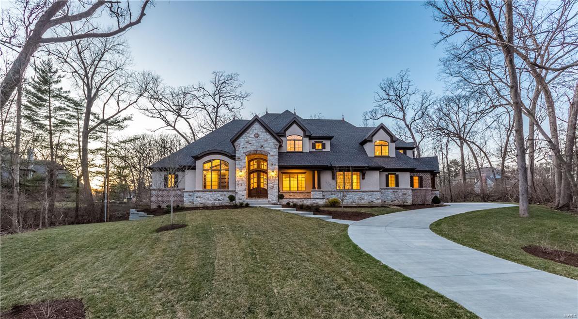 READY NOW! Flower Signature Custom 1.5 Story Design in a prime Frontenac location. On a secluded wooded acre walk-out site suitable for a pool, this beautiful home dressed in stone and stucco sports 6 bedrooms (one of them a guest suite on the first floor & another a huge nanny suite on the second floor) and 8 baths. Its features include the vaulted "Gathering Room" where the gourmet kitchen, breakfast room & family room w/ stone fireplace open to a sunny garden hearth room. An overlook balcony, a bonus room, 2nd laundry area & staircase are featured on the second floor. Flanking the coffered foyer, is a private vaulted study with bookcases and a gracious dining room. The family foyer leads to an oversized 4 car garage, mud room with cubbies and the covered side porch. L.L. recreation rm, wet bar, B.R. & Bath. Expect hardwood floors, custom cabinetry with granite tops, 8 ft solid doors on the first floor, central vac, 3 zoned HVAC, security sys, sprinkler system and so much more. Additional Rooms: Mud Room