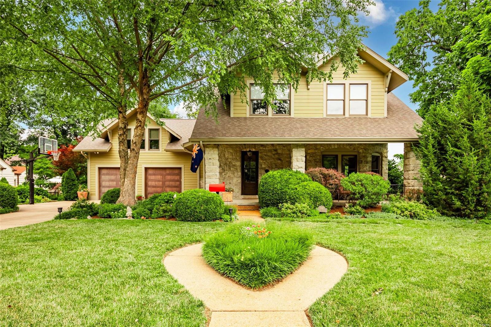 A true architectural show stopper both inside and out - from the large, welcoming front porch, to the millwork throughout to the substantial stone exterior that is carried into the interior of the home- this is a true stunner. The main level boasts great space and charm throughout, starting with the two-sided gas fireplace between the front living area and dining room, an updated gourmet kitchen, laundry area, a second living area with large windows offering views of the stunning rear yard and a access to a screened in porch, which leads to a nice deck and patio area. The second level has three large bedrooms, a hall bath, a lovely primary suite, and a generously sized bonus room which is a great flex space-workout room, art studio, etc. The unfinished lower level offers even more opportunity for finishable space. You will be amazed with the lush gardens and pool area plus the large amount of green space. This home is a rare find in the area, and truly a “must see”!