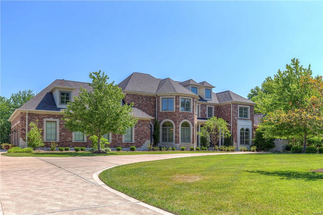 Custom-built Estate home on parklike 1-acre grounds! Homer Award-winning 1.5 Sty features over 7600 sf of living space enhanced by Brazilian cherry & marble floors, expansive windows, 10’ ceilings & extensive millwork. Extraordinary 9’ wrought iron double doors lead to 2-sty foyer with architectural columns, private study with built-in bookcases, elegant dining room & stunning great room with dramatic 2-sty bow window & granite fireplace. Exceptionally large kitchen with professional quality appliances, granite countertops & cherry cabinetry adjoins light-filled breakfast room & coffered hearth room with stone fireplace & French doors that open to deck. Sumptuous master bedroom suite with 2 walk-in closets & lavish bath with Jacuzzi & shower spa offers an appealing retreat. Front & rear staircases access 3 additional ensuite bedrooms. Incredible walk-out Lower Level includes recreation room, game room, 2nd kitchen & ½ bath. Professionally landscaped lot with deck, patio & 3-car garage.