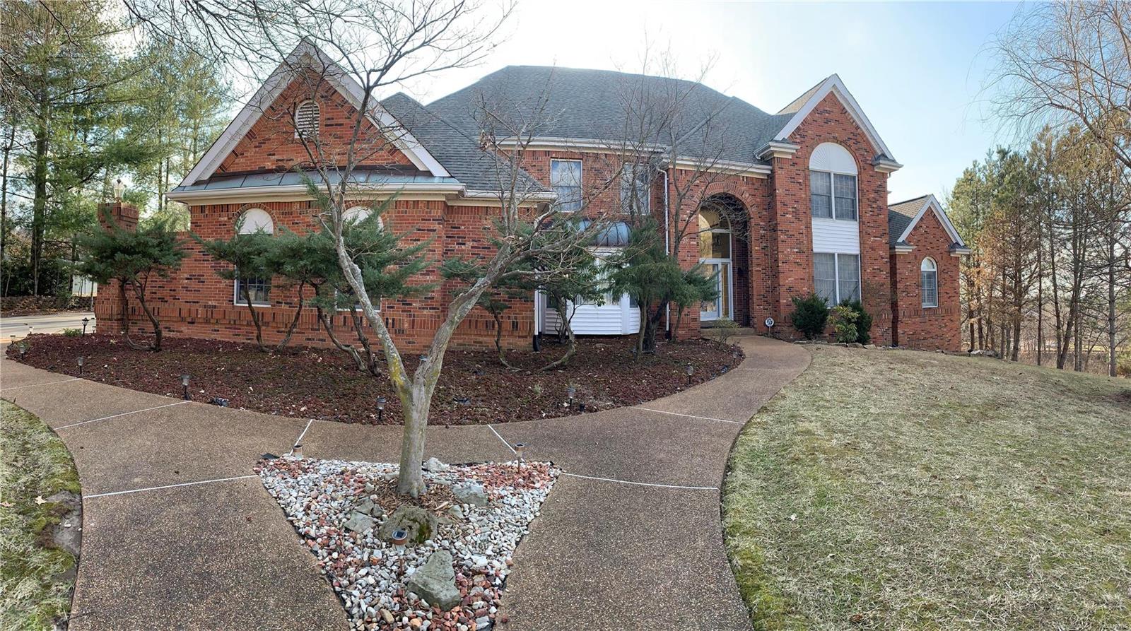 Beautifully designed brick 1.5 Sty in premier Town & Country location. Center hall floor plan features well-proportioned rooms with oak hardwoods, soaring ceilings & detailed trim work. 2-Sty marble foyer leads to formal living room, elegant dining room with tray ceiling & stunning great room with marble fireplace, wet bar & wall of windows that overlook parklike backyard. Chef’s kitchen with white cabinetry, stainless steel appliances, butterfly center island & convenient planning center adjoins octagonal breakfast room with beamed ceiling & atrium door that opens to deck. Coffered master bedroom suite offers an appealing retreat with luxury bath with jetted tub & stained glass door to sun porch. T-staircase accesses 4 additional bedrooms with Jack n’ Jill baths. Lower Level includes recreation room with fireplace & wet bar, dining room & family room plus 6th bedroom, full bath & guest suite with kitchenette.  Situated on a 1+-ac cul-de-sac lot with deck, patio & landscaped gardens.