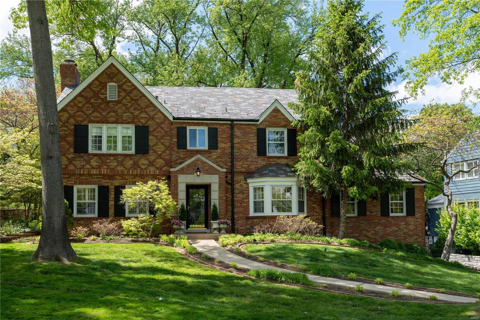 INCREDIBLE NEW PRICE! Stately Ladue Home in the Tree Lined Fair Oaks Neighborhood. Prepare to fall in LOVE with this traditional upscale floor plan offering hardwood floors, built-in bookshelves, beautiful moldings and large bright windows throughout. Gracious entry hall welcomes you with a sweeping staircase and elegant LR with fireplace and large DR. TWO wonderful family rooms to entertain all of your favorite people and a bright white kitchen with views of private backyard. Second floor boasts 4 spacious bedrooms & 3 newly Updated Full bathrooms. Expansive Primary suite has vaulted ceiling & spa-like bath with large walk-in closet. Bonus finished lower level offers additional family/rec room, mudroom off 2-car tuck under garage & plenty of storage. Spectacular landscaped lot, with walk out patio, wonderful backyard space, and fire-pit. Incredible opportunity to live in one of Ladue's finest neighborhoods, with incredible access to Ladue, Clayton and Highways. Rare find! Additional Rooms: Mud Room