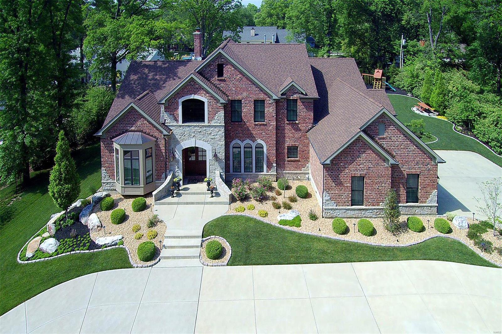Spectacular estate home defined by timeless architecture & a sense of rustic elegance! Over 6000 sf of living space enhanced by soaring ceilings, elaborate millwork, plantation shutters & wide plank oak flooring that flows throughout the main floor. Impressive 2-sty hardwood foyer leads to private study w/ 12’ ceiling & wide bay window, coffered LR & stunning DR w/ marble fireplace flanked by built-in bookcases & 9’ wet bar. Designer kitchen featuring glazed white cabinetry, granite countertops & commercial grade appliances adjoins light-filled breakfast room. A vaulted ceiling w/ hand hewn beams & floor-to-ceiling stone fireplace set the tone for the hearth room. Sumptuous mstr bedroom ste w/ lavish bath w/ Jacuzzi offers an appealing retreat. Front & rear staircases access 3 addl bedrooms, 1 w/ ensuite bath & 2 w/ Jack n’ Jill bath + bonus room. Professionally landscaped ¾-acre grounds w/ patio & fireplace & 3-car garage. Easy access to a horse/nature trail for outdoor activities.