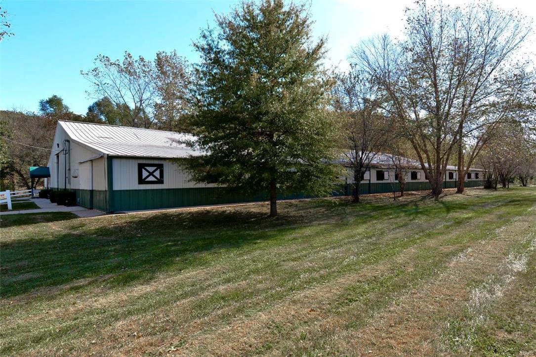 Horse Property/Farm! Wildwood! The ultimate investment opportunity for those who could utilize the boarding/training facility as a profitable business. 31 acres for sale, approx 16 acres of training area/pasture offering one of the finest horse facilities around, plus 5 potential lots to build custom homes. There are 45 equipped stalls (potential for 63 stalls), 25 of which are Classic Equine (Brazilian cherry wood). Barn facility has a vast 70x120 ft indoor riding arena w/rubber footings, stalls crafted from gorgeous Brazilian cherry wood w/fly spray system, automatic watering system, cleaning bags, rubber mats, mirrors in each corner of arena, 2 offices, 2.5 baths, T8 lighting, lounge, & 7 fenced turn-out pens. Outdoor arena complete w/jumps. Hay barn, work barn & up to 2.1 acres for manure storage equipped w/septic & deep well are featured. Caretaker's home is a 2bed 1bath living space. Other business opportunities include dog/horse breeding, tree farm for landscaping & MORE!!!