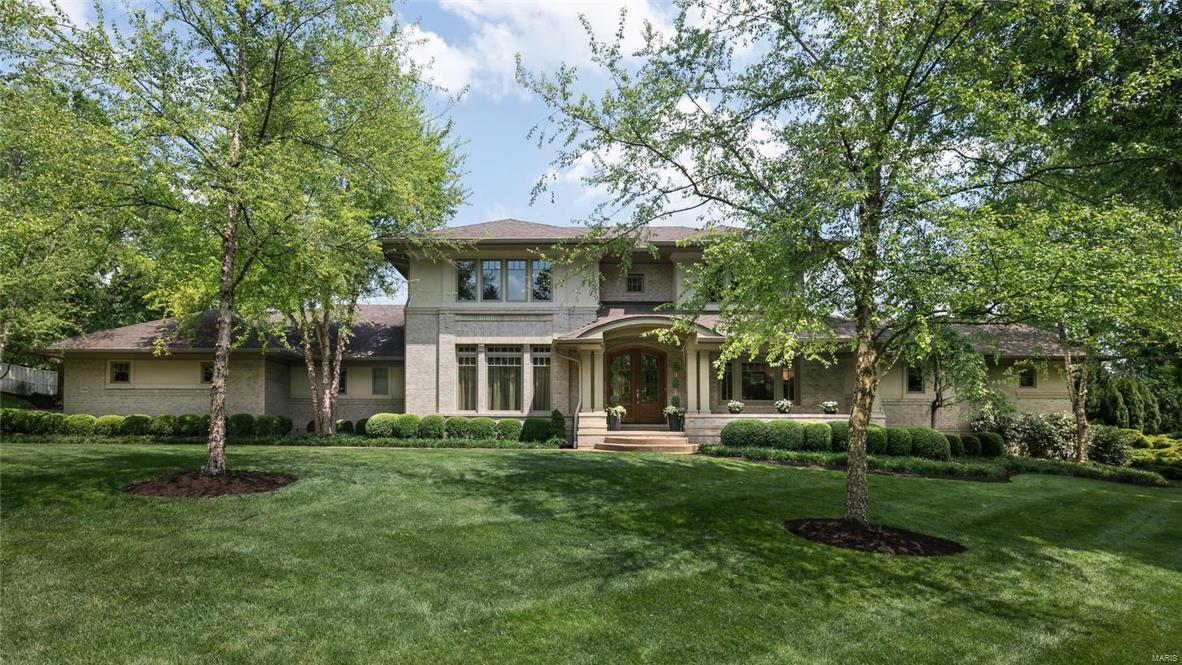 Incredible new price on this exceptional 11 year old home in the heart of Ladue!
 This 4bd, 4+bath home offers an open floor plan, arched doorways, wide plank maple wood floors and spacious room sizes throughout. Main floor master suite w/ spa-like bath, private laundry and large walk-in closet with custom built-ins.The chef's kitchen with stainless appliances and honed granite counter tops & custom Markus cabinetry opens to a wonderful hearth room with vaulted ceiling and gas fireplace. Butler's pantry with subzero wine cooler, formal dining room with coffer ceiling , 2 powder rooms, den/office and living room with soaring ceiling height, built-in bookcases & second fireplace.  Upper level boasts 3 beds and 2 baths, walk-in closets and  laundry room. Finished lower level with additional family room, wet-bar, exercise room, craft room, & full bath. 
 Patio overlooks custom saltwater pool & hot tub is perfect for entertaining!
 3 car attached garage and lovely manicured grounds.