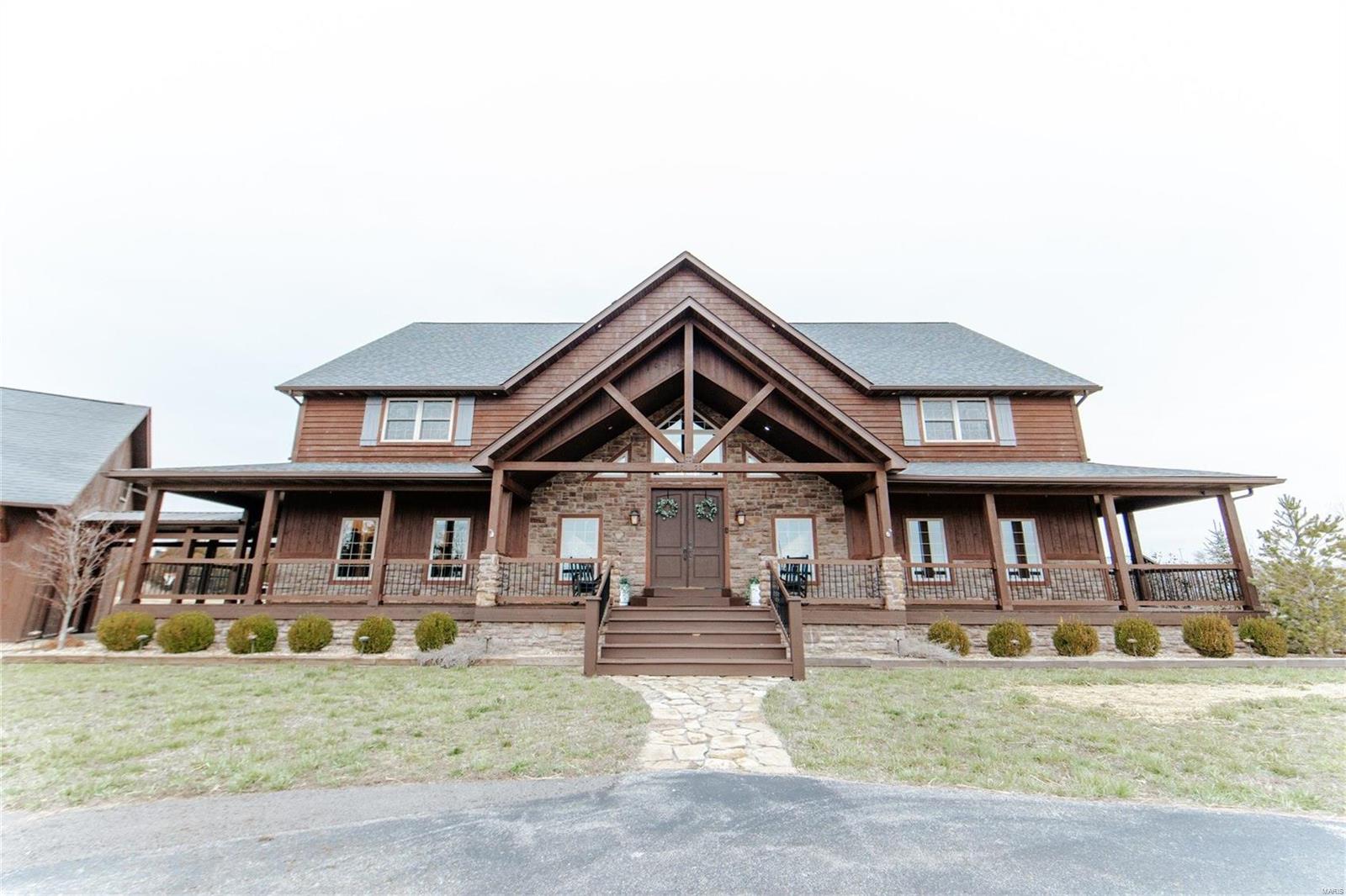 Grab your kayaks and fishing poles!
This INCREDIBLE *one of a kind property* is up for grabs! 
This stunning lodge was built in 2011, and is completely custom inside + out! 
Boasting a massive living space with a window wall, vaulted ceilings, & wood beams throughout!
Home also features a beautiful rustic + country kitchen, 5 bedrooms, a loft space, 4.5 baths, a finished walk-out basement with a bar, theater room, and tuck-under garage! 
Don't forget the detached 3 car garage, with an upstairs barn loft, and enormous 60X80 shop with a lean-to, 4 garage bays and 4 man doors! 
You will not want to miss this absolute DREAM HOME, sitting on 15+/- acres with a lake view out back, and a quarry! Call TODAY for a private tour!