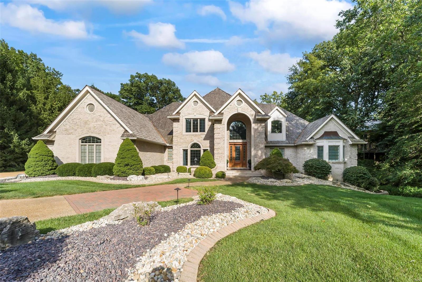 This stunning home is the epitome of luxury & comfort. Located in desirable Stonebridge, this custom-built Lantz Home boasts exceptional craftsmanship & luxurious features. Step through the grand entryway & you'll notice the custom woodwork that sets this home apart. The kitchen is a chef's dream w/ granite countertops, stainless steel appliances, & ample storage space. Work from home in the luxurious office, complete w/ fireplace, patio & stunning view of the backyard. The main floor primary suite features a luxurious en-suite bathroom, 2 walk-in closets & sitting area. The upper level boasts 2 bedrooms, 2 bathrooms, & a loft. The lower level features a custom bar, exercise room, home theater, & additional BR & bath. For the golf enthusiast, there's even an indoor golf room & step outside to find not 1, but 2 outdoor putting greens & a target green. The outdoor kitchen is perfect for hosting summer barbecues. Meticulous attention to detail makes this home stand out from the rest.