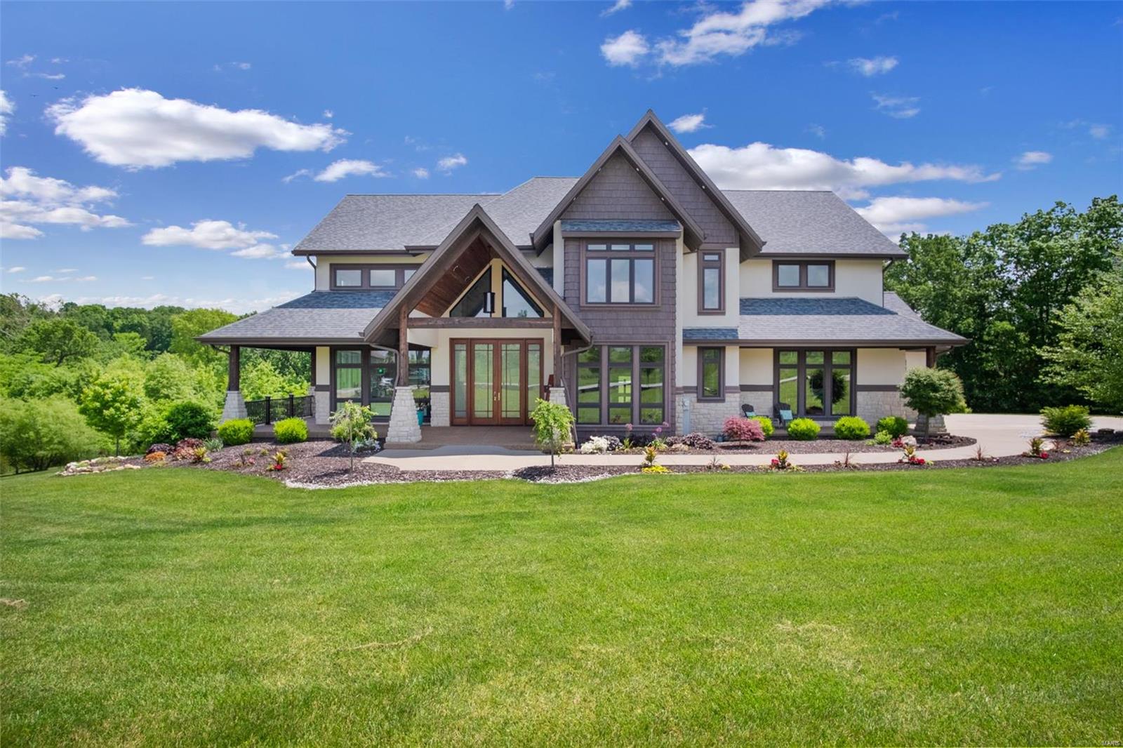 This luxurious custom home on 3+ acres backing to woods w/a heated saltwater pool will thrill those who love clean, modern, linear design. Soaring ceilings, endless Anderson mulled windows, hand-scraped walnut floors & custom lighting flow throughout the main level. Beautiful chef's kitchen features custom shaker cabinets w/lighting above & below, quartz counters, a natural stone backsplash & stainless steel appliances, including a double wall oven & 5-burner cooktop. Hearth room w/a stone fireplace & vaulted ceiling w/a wood beam opens to the composite covered deck overlooking the woods. Custom built-in furniture pieces in almost every room. All bedrooms have private bath access & 3 have zero-entry tiled showers w/multiple shower heads. Elevator accesses all 3 floors. Home theater w/surround sound. 2 BR/2BA amazing in-law apartment. Geo-thermal heating/cooling. 3-car side-entry garage. Just 4 miles from I-64 & served by Francis Howell Schools.  See this one-of-a-kind delight today! Some Accessible Features