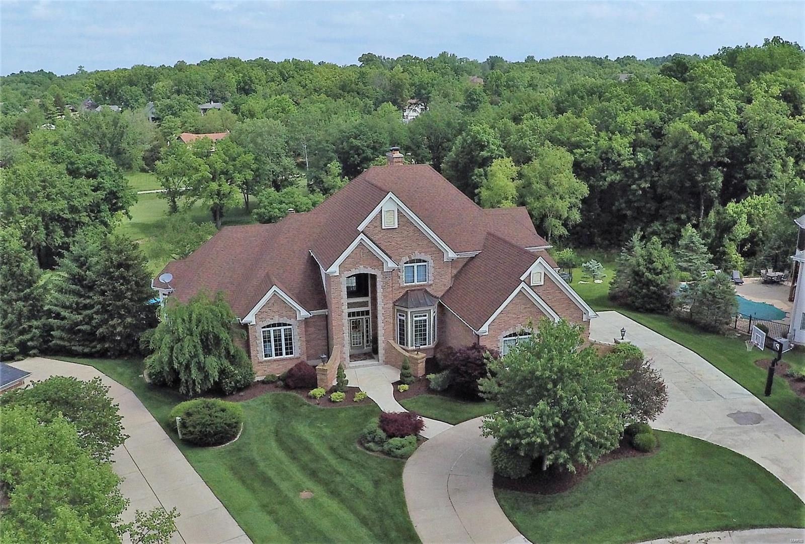 Prepare to be wowed with charm and quality at every turn. Impressive great room with soaring ceilings and a wall of windows framing scenic views of the pool and golf course.  Sophisticated gourmet kitchen boasts high end appliances, granite, center island, separate breakfast area and hearth room. Serene and spacious master suite adjoins the office with rich wood details and private coffee bar. Including an en-suite luxury bath with over sized shower, whirlpool tub, his and hers vanities and closets. The lower level includes a custom designed theater room with fireplace, wet bar, wine room, exercise room and additional bedroom. The home is a smart home including security, audio and temperature. A resort-like backyard invites relaxation from the sounds of your own waterfall, raised infinity edge pool, large patio areas and deck for outdoor dining overlooking hole 17 of the prestigious Lake Forest Golf Course.