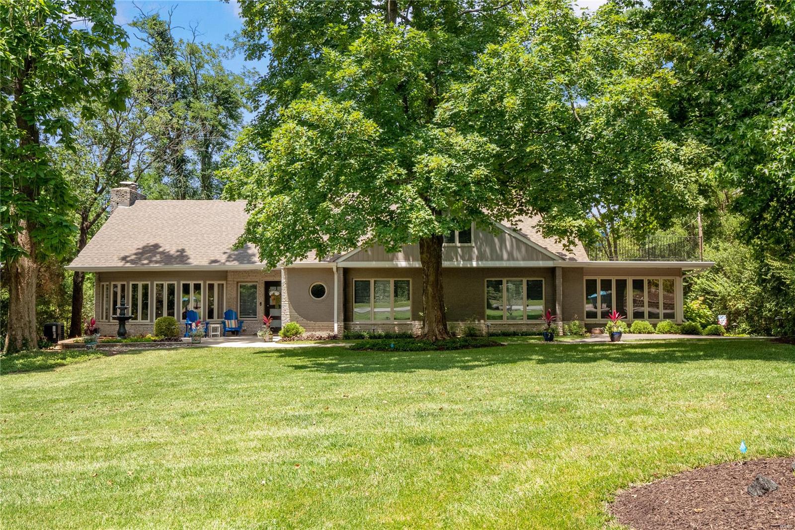 A true gem and restful retreat masterfully completed for today's lifestyle.Mature landscape and nature surrounds the exterior of this modern and elegant home.Once you've arrived on property and step inside this over 4500 square feet of open concept transitional living space you know you have arrived somewhere very unique and special. Gorgeous walls of windows surrounding the space visually bring the outdoors in! Incredible entertaining home with an open concept living room featuring fireplace, dining room and gorgeous chef's kitchen and beautiful hardwood floors.Step directly outside onto an enormous private and serene covered outdoor living space surrounded by your 1.22 acre wooded view.Main floor primary bedroom suite has a private sitting room,amenity bar with wine cooler and spacious master bathroom featuring freestanding tub and large separate shower. You will find 3 additional large bedrooms upstairs, one with ensuite and private balcony, comfy and up2date LL plus a 3-car garage! Additional Rooms: Mud Room