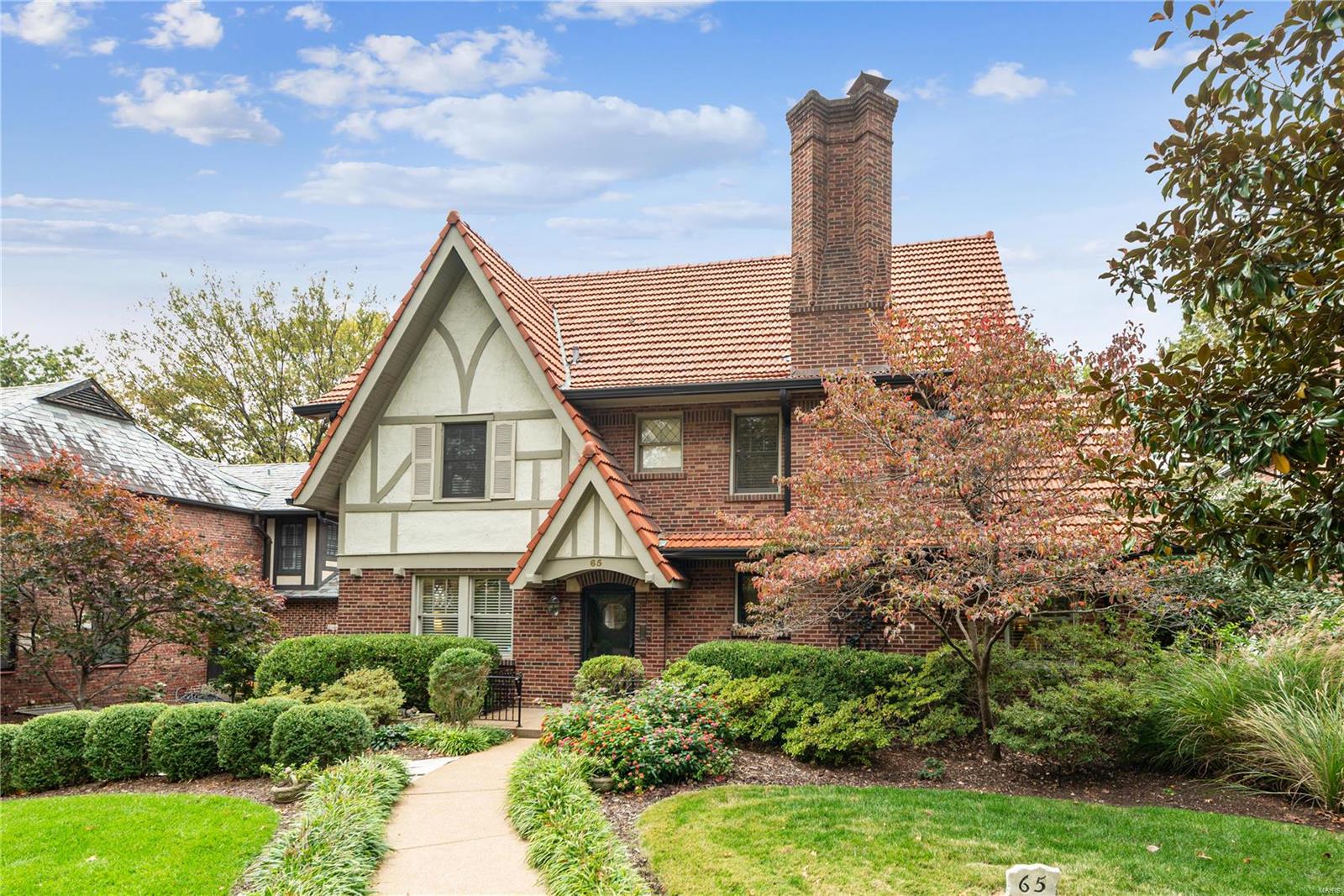 Welcome to 65 Ridgemoor Drive: a timeless Tudor residence in Clayton’s Claverach Park neighborhood (listed on the National Register of Historic Places). This home was completely renovated & significantly expanded in 2002 creating a seamless marriage of traditional charm & modern conveniences. The living spaces were envisioned with entertainment & comfort in mind. Beautiful hardwood floors guide you through the formal living & dining rooms to a spacious eat-in kitchen/great room with built-in cabinetry & wet bar. Relax on the screened-in porch, a natural extension of the great room. Upstairs, the oversized primary bedroom has two closets & a spa-like bathroom. There are three additional bedrooms & two additional bathrooms. Second floor laundry room completes this convenient floor plan. Other features include oversized attached 2 car garage, 750 bottle wine cellar & main floor office. #65 is one of only 15 homes of the 210 in Claverach Park that faces Clayton’s elegant Oak Knoll Park. Additional Rooms: Sun Room, Wine Cellar