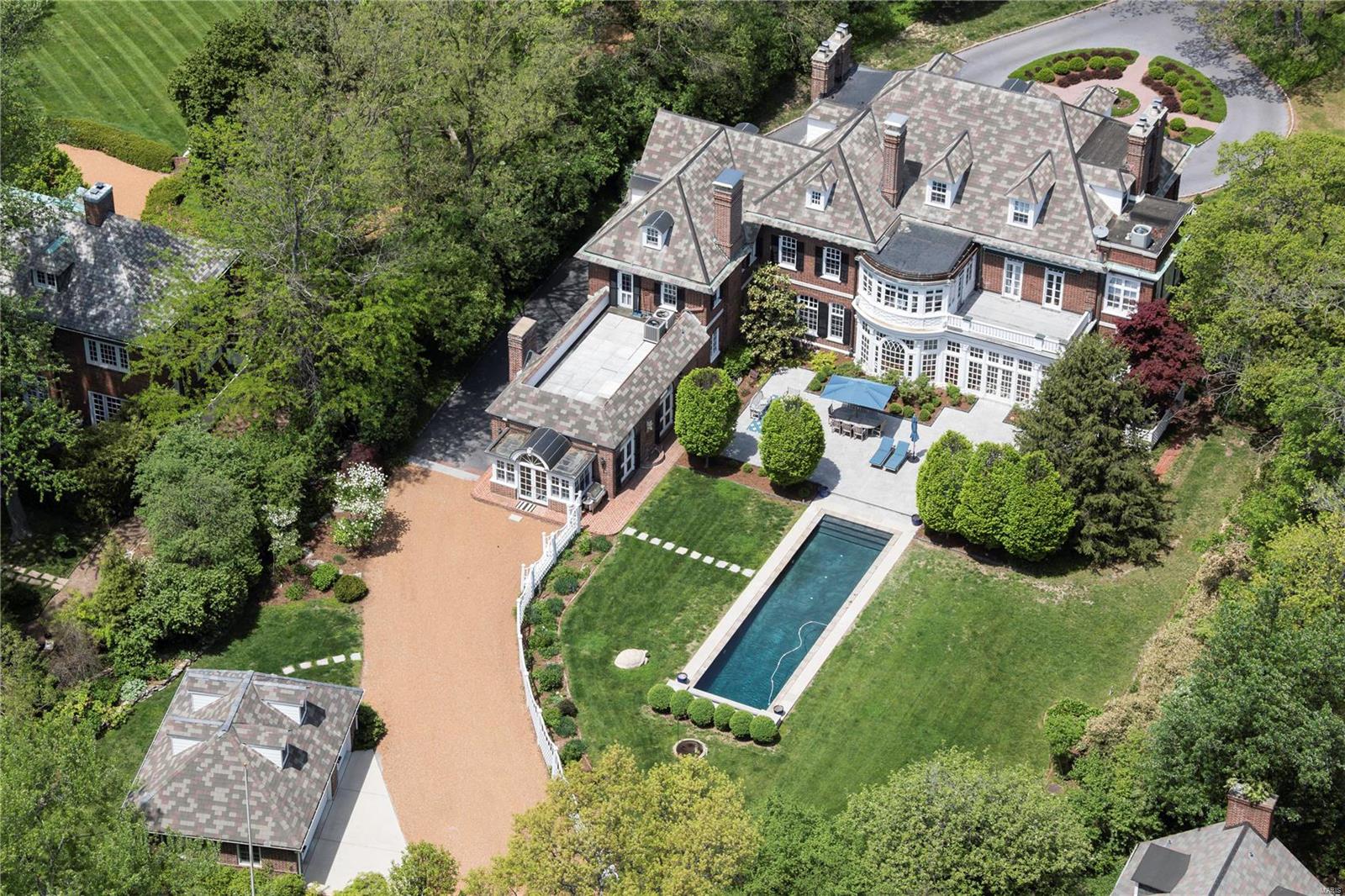 This refined Brentmoor Park estate offers every modern benefit while maintaining the opulence and extravagance of a bygone era. #4 East Brentmoor is one of Clayton's finest showcases; impeccable, in manicured lawns, artful grounds, magnificent pool, patios and terraces. Elegant and graceful, inside and out, the exterior is composed in notes of a stamped concrete circle drive, greenhouse, Carriage House and gardens. The main house is thoughtfully renovated, throughout. A chef kitchen and hearth room, and expansive sunroom, align with classic oversize living and dining rooms. The Master retreat and office have breathtaking views of the pool and gardens. Dual dressing rooms and a marble bath complete the suite. All bedrooms enjoy a fireplace. Ideal for entertaining or fundraisers, the private gated entrance opens to Wydown Boulevard, for strolls to boutiques, Bar Les Freres, I Fratellini, Billy Jean and Starbucks. An exclusive lifestyle resting on 1.5Acres. Elevator service to 3 levels. Additional Rooms: Sun Room