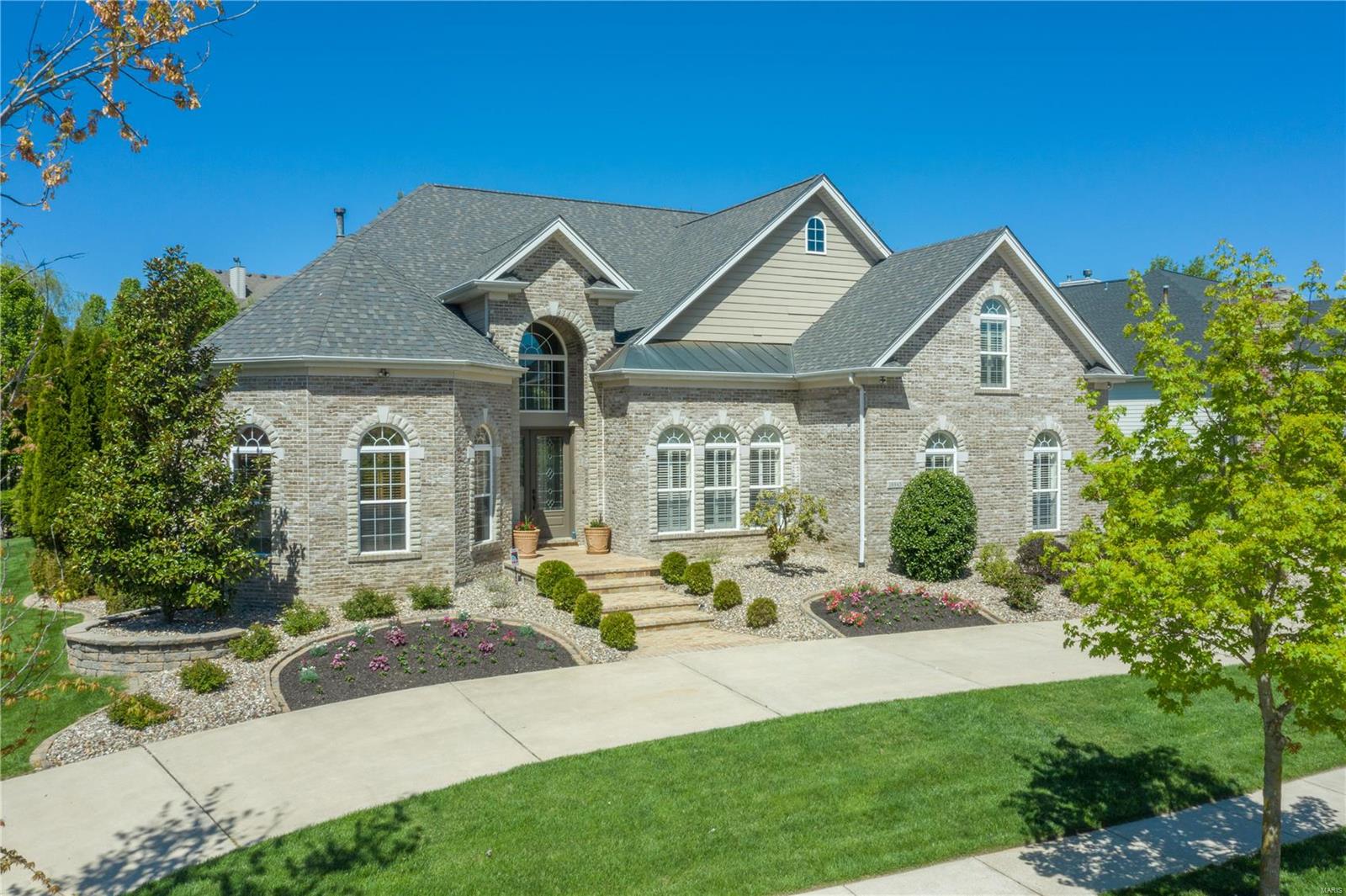 Spectacular 1.5 story has the “wow factor” and convenient location. Exceptional design features include a grand foyer, large study w/ 12’ ceilings & beautiful millwork. Enjoy entertaining in the formal dining room featuring a coffered ceiling. The stunning 2-stry great rm is an entertainer’s dream w/ a gas fireplace & a bar that can be served from the kitchen. A stunning kitchen offers gorgeous cabs, updated tile backsplashes, a Wolf 6 burner range w/ double ovens, a convection micro, 2 warming drawers & opens to a breakfast room & hearth room w/ boxed beam ceilings. An updated main floor master retreat has a sitting room w/ fireplace & a beyond-luxury bath. The upper level features 3 bdrms, a loft rec. room & a bonus room which can be a 5th bdrm or media room. Relax in the stunning outdoor living area w/ a covered patio featuring big timbers, custom iron, stamped concrete, stone fireplace & built-in grilling area w/bar. Additional features include circle drive & plantation shutters
