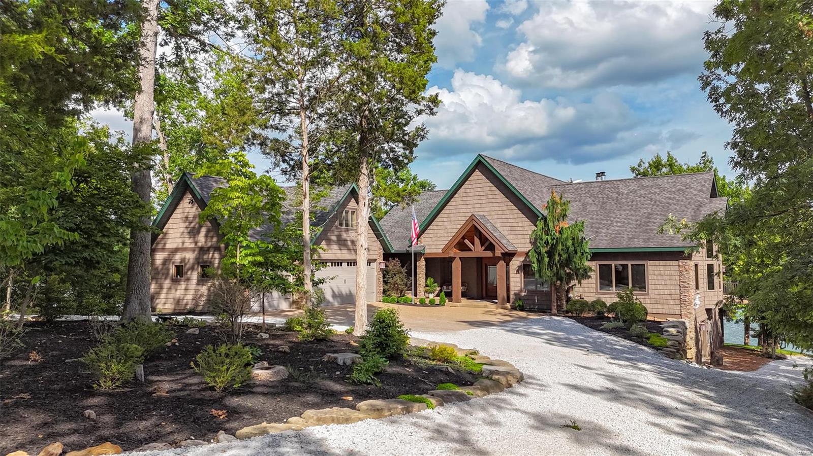 Unparalleled luxury living on the shores of 236-acre Alpine Lake. Boasts a 3-car garage with a bonus room, stone accents, and a covered entrance and breezeway leading to the back deck. Completely remodeled throughout, the stunning open floor plan with two cozy sitting nooks, a great room with a stone wall fireplace and vaulted ceilings, a dining area, and a stunning chef’s kitchen highlighted by a center island, new appliances, quartz countertops, modern lighting, and a large breakfast bar. Expansive windows line the entirety of the back elevation, providing breathtaking lake views and natural light . The main level includes a pristine home-office, and a large primary suite with a private balcony. The LL feature a workout area, entertainment area with a pool table, 2nd rec room, 3 additional BR and 2 BA. Walk-out access leads to a spacious stone patio, fire pit area, and stone path to the shoreline, a private dock, 2 lakeside sitting areas, and an expansive deck with a covered portion. Additional Rooms: Mud Room