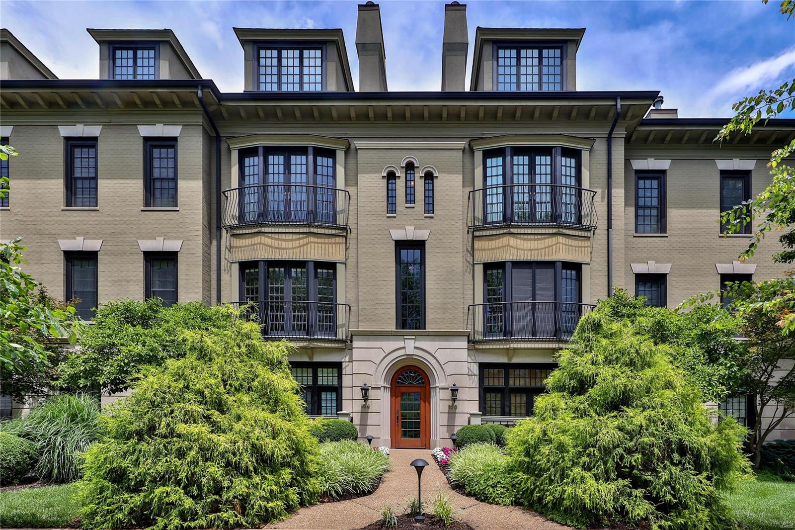 Very desirable condo in an elegant building perfectly located in the heart of Clayton.  The gracious exterior details continue in the interior, beginning with a large Entry flanked by columns opening to generously sized rooms. Inviting Living Rm features an expanse of glass with French doors & balcony with park views. The classic fireplace (gas) paired with built-in bookcases create another focal point.  Spacious Dining Rm can accommodate your guest list, large or small.  The renovated kitchen showcases Marc Christian Fine Cabinetry and gorgeous Danby marble countertops.  Wolf, Subzero and Bosch appliances. Sitting Area/Breakfast Rm features a wall of windows and atrium door leads to a large covered deck with privacy created by specimen evergreens.  An oversized Primary Bedroom provides ample space plus luxurious bath & organized walk-in closet.  2nd Bedroom could double as office/guest suite with attached bath.  Powder Rm & Laundry complete the picture for convenient one level living.