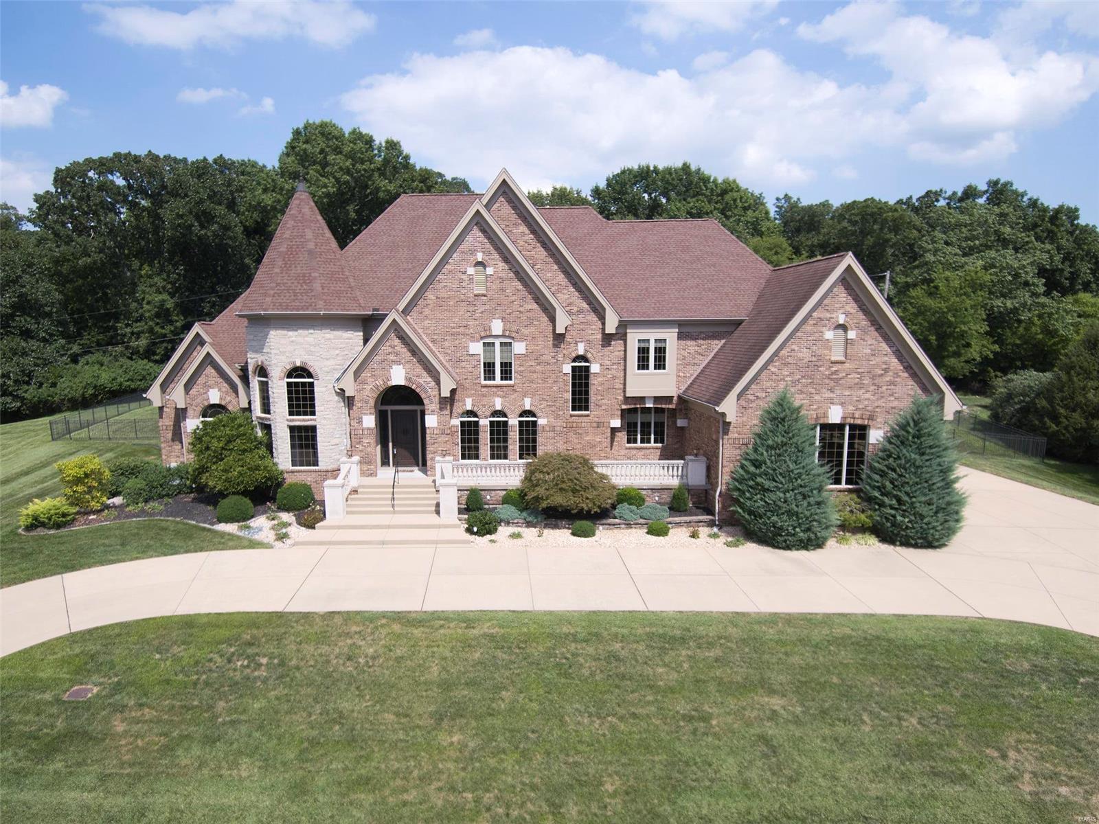 Back on the market - no fault to seller! you MUST see this Custom built 1.5 story (8900+ sq ft). In one of the most prestige sought out subdivisions.   Kitchen (remodeled) is every cooks dream including all Viking Professional appliances. The Cambria quartz counters are BEAUTIFUL along custom cabinets, stained glass doors, Swarovski Strass Crystal Chandeliers (several of these throughout home) wine cooler & more. The open hearth room has gas FP w/ built in TV, speakers, coffered ceilings. The den/office has floor to wall custom wood paneling. Great Room w/ 20' ceilings, gas FP & screams elegance! Master is huge & has his/her closets. Master bath has WI shower, jetted tub, custom blinds, his/her vanity. Upper level features 3 large BR, all with WI closet and each bedroom has own full bath. Theater room has projection TV, stadium seating & custom drapes. LL has full kitchen, bedroom, bar, workout room/rec area, living room and storage.  Inground pool w/ prof landscaping.