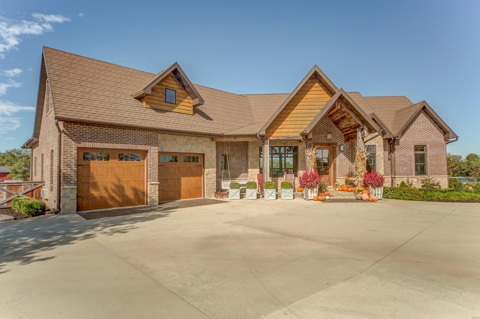 Gorgeous, luxury five bedroom, five bath brick home. Outside has custom lighting & landscaping, saltwater pool, hot tub, gas fireplace, and a covered porch with a fireplace & TV. Inside, kitchen has an 18 ft butcher block island, two farmhouse porcelain sinks, Wolf gas stove top with a pot filler faucet, a subzero refrigerator,  and a double oven.The main floor laundry is  a dream as it filled with counter tops and cabinetry.  On the main level are two mudrooms and three bathrooms, including the master suite. The main level master suite has a large bathroom finished in a crisp white finish with separate tub and shower plus a walk-in closet with shelving.The upstairs of this story and a half home is a bedroom with a great view and built-in shelving and a private bathroom. The basement also has a family room with fireplace, bar, three bedrooms, two bathrooms, and a laundry room. This 51.5 acres has an ATV playground, two very impressive outbuildings, and serious garage space! Additional Rooms: Mud Room